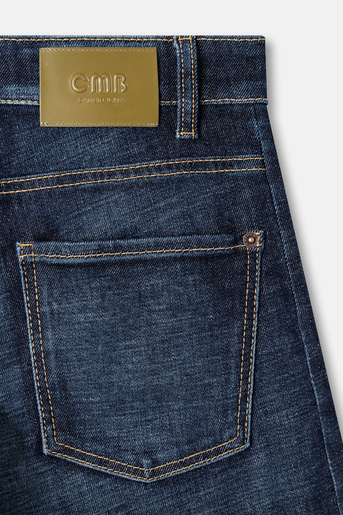 Close-up of back pocket detail on Cambio Oria Cross dark wash denim jeans with gold leather label
