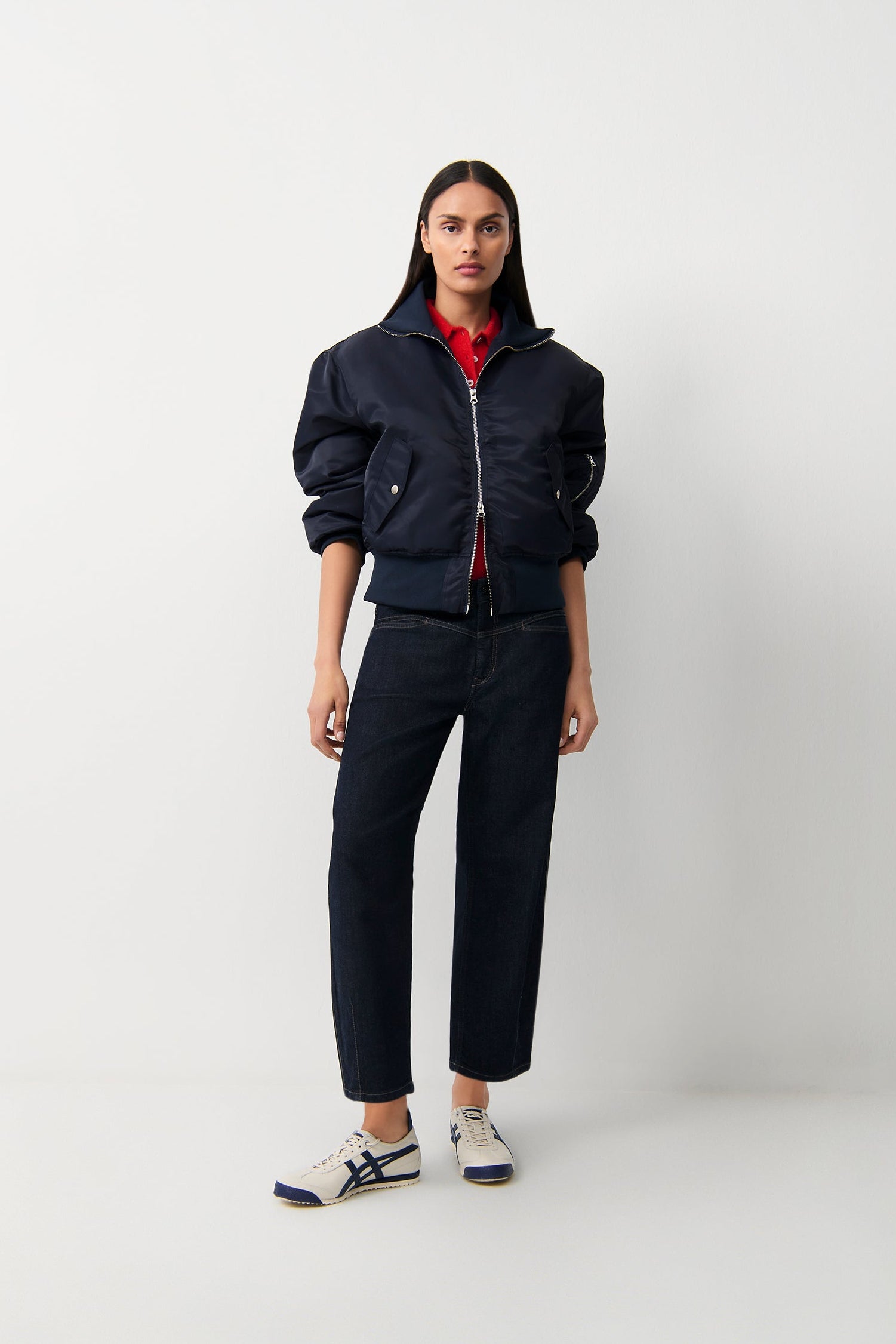 Model wearing Cambio Elin Modern Rinsed dark indigo straight-leg jeans with navy bomber jacket
