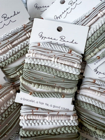 Gypsea Bands hair tie bracelet set in sage green and white on branded packaging card