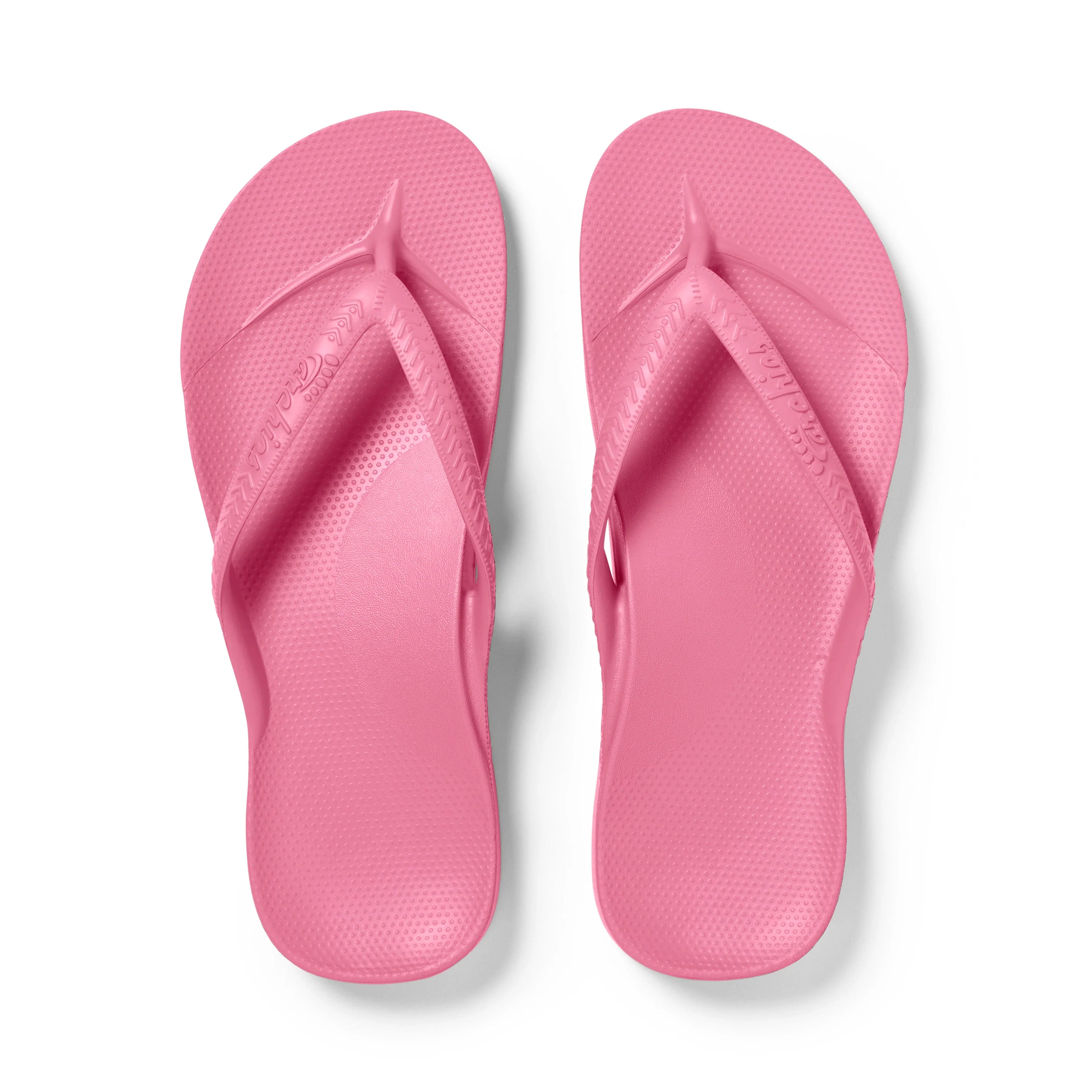 Archies Hot Pink arch support flip flops shown from above on white background