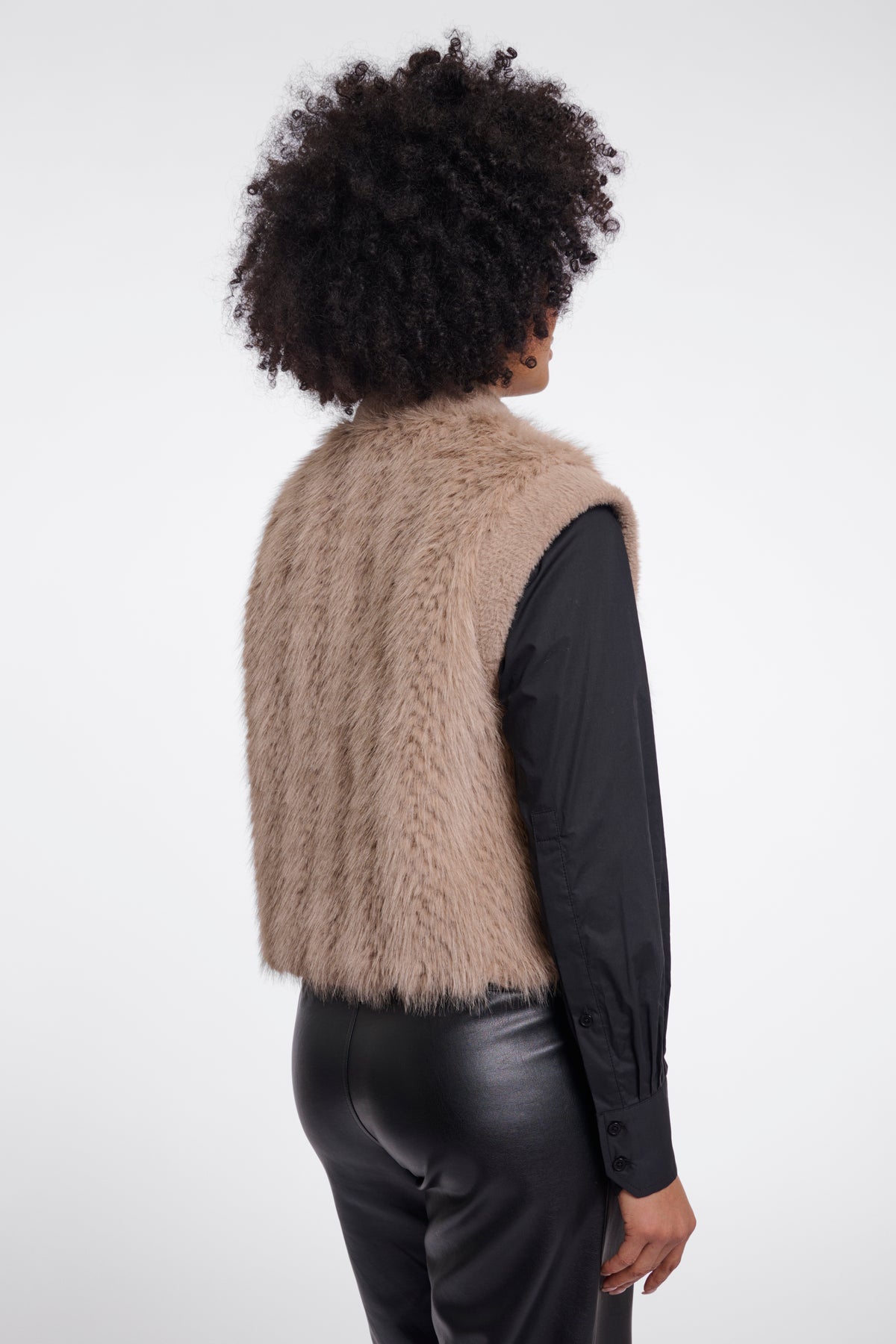 RINO & PELLE Alvita taupe faux fur vest worn over black shirt and leather trousers