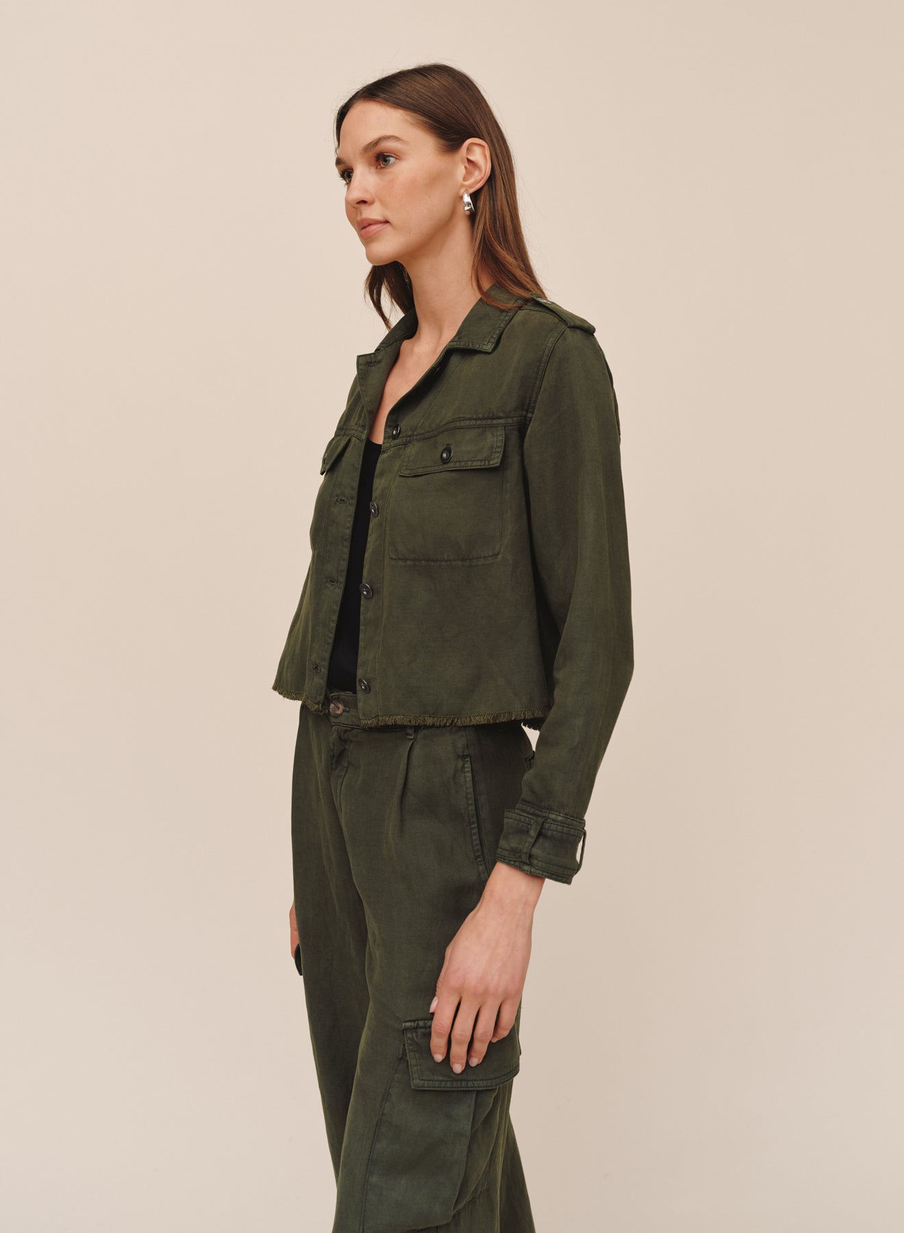 Model wearing Bella Dahl cropped utility jacket with fray hem in smoked olive, side view