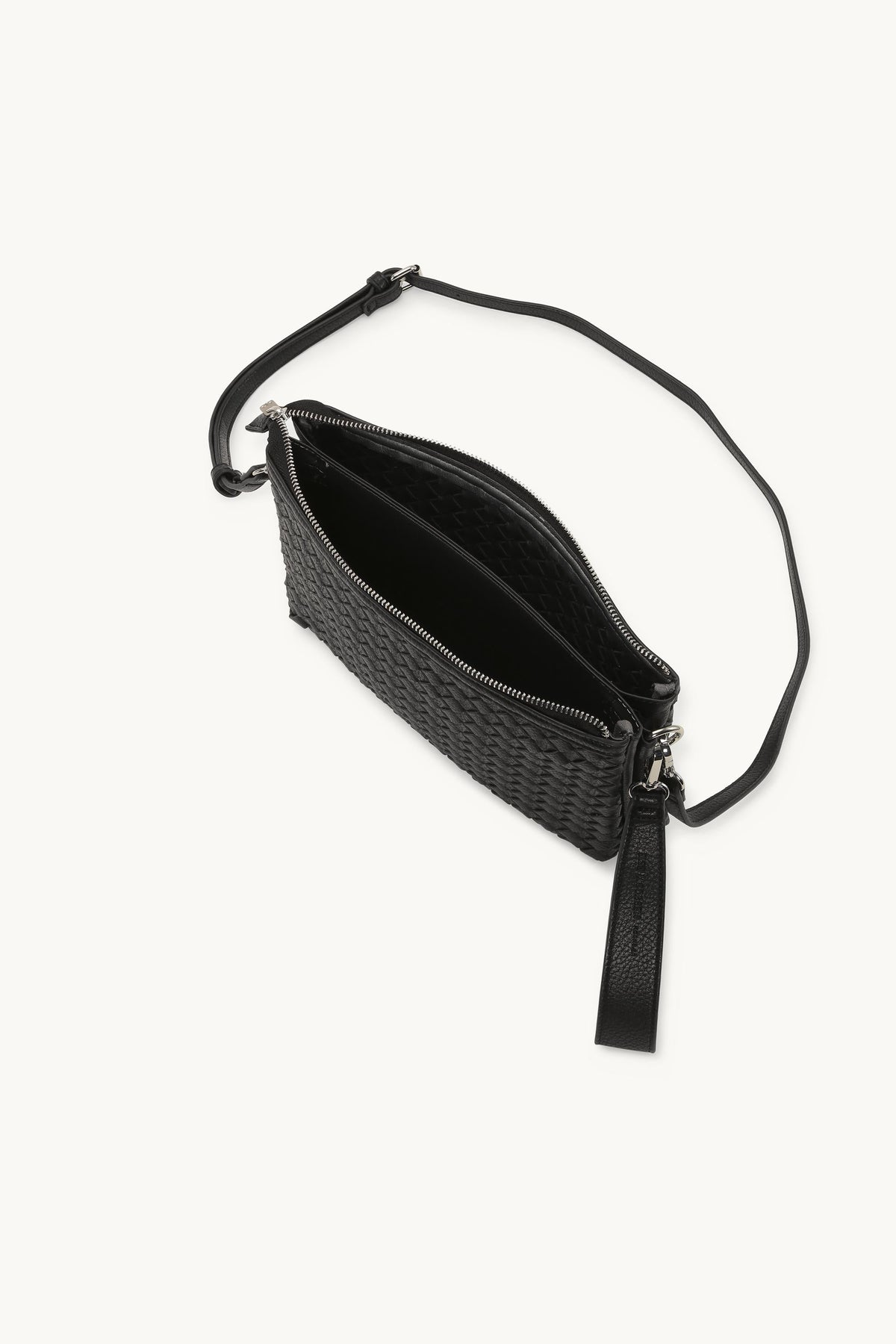 Black woven leather crossbody bag open showing interior with adjustable strap