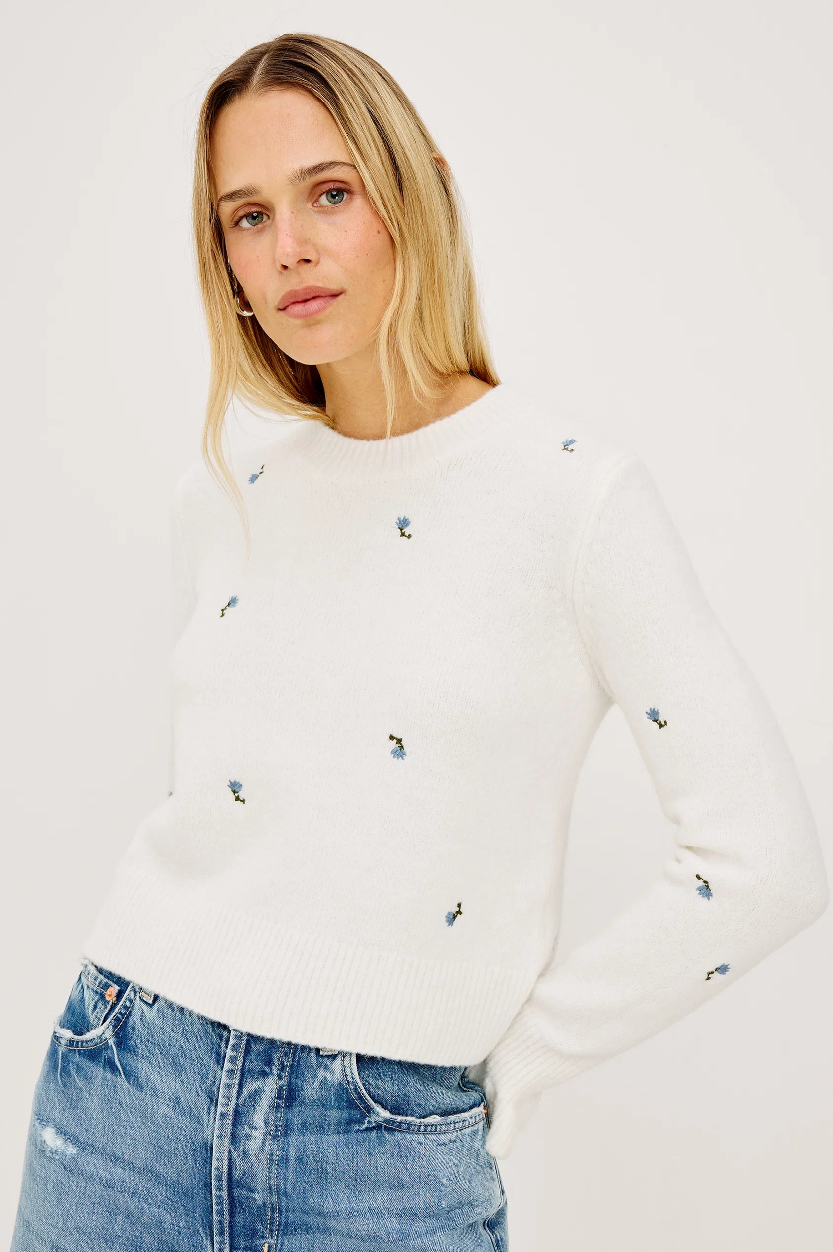 White wool-blend crew neck sweater with scattered blue floral embroidery, long sleeves