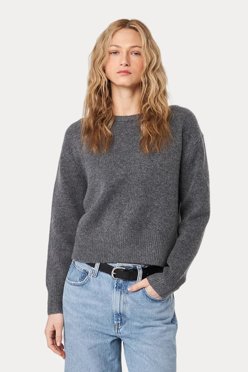 Woman wearing JOHN & JENN Wilfred grey knit crewneck sweater with light blue jeans