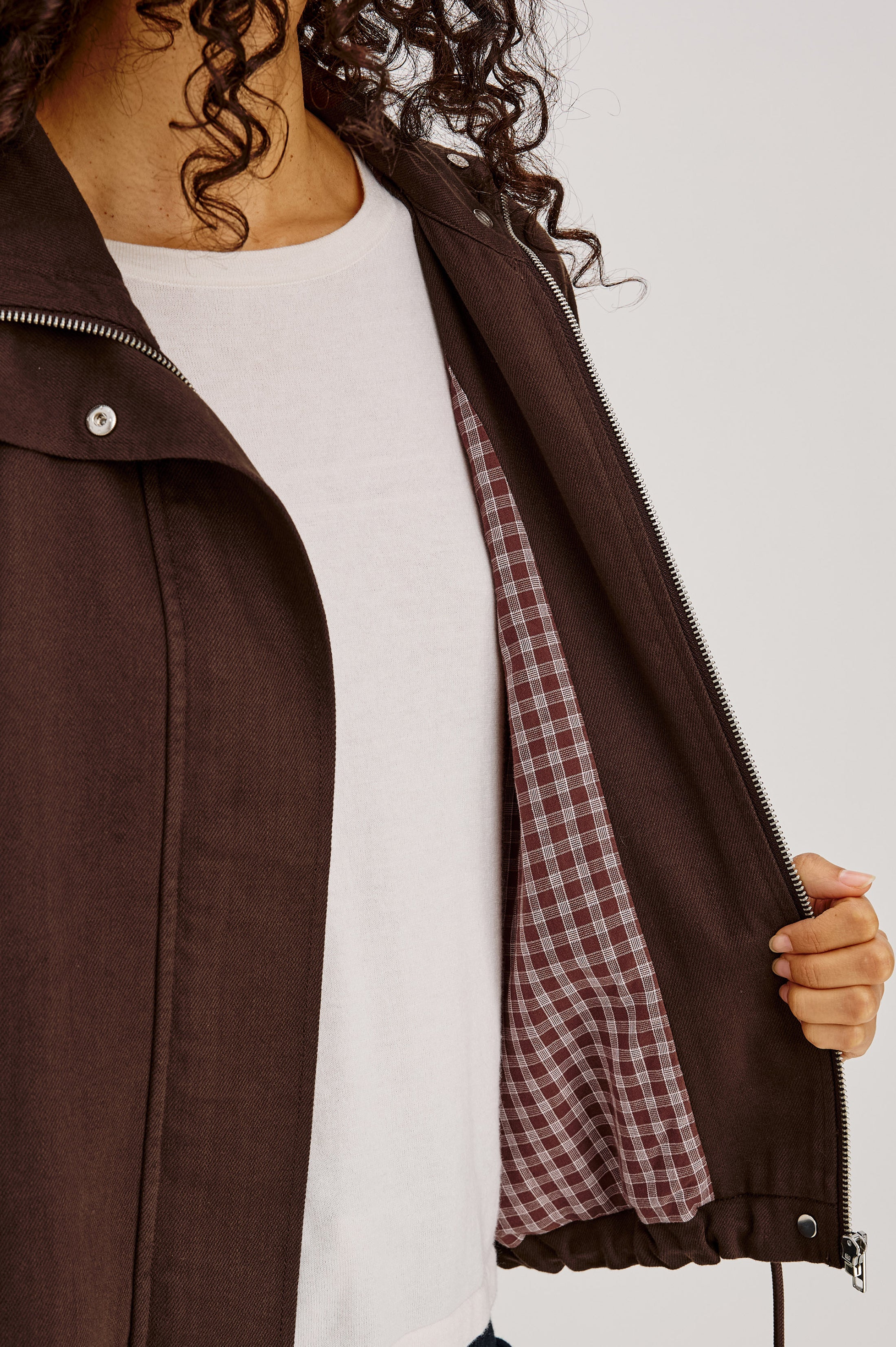 Close-up detail of Rails Blake jacket in espresso showing zipper and plaid lining interior.