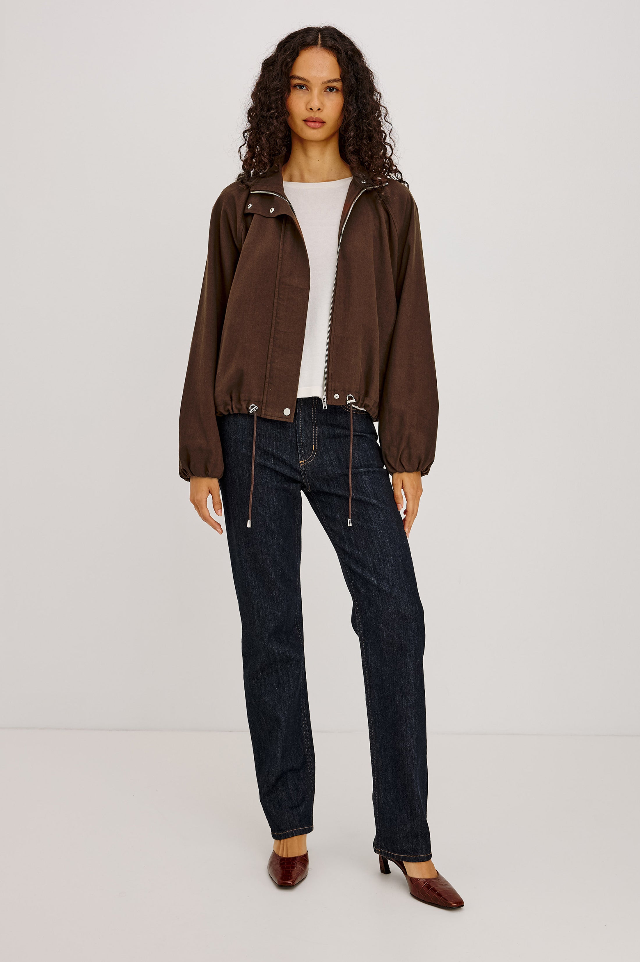 Model wearing Rails Blake jacket in espresso dark brown with drawstring hem and white tee