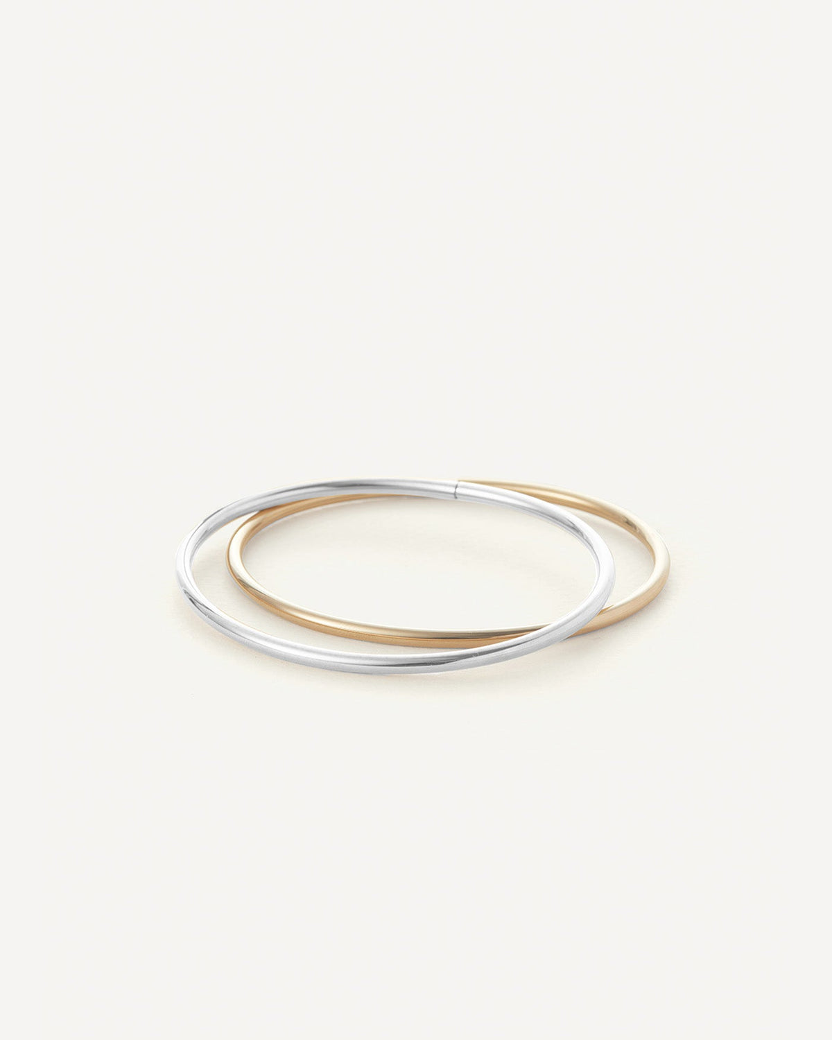 Jenny Bird Dane Bangle Set of two interlocked bangles in silver and gold tones
