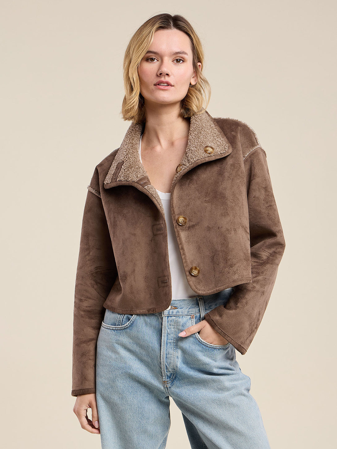 Model wearing Velvet ESME07 cropped faux shearling jacket in faded coco brown with button front