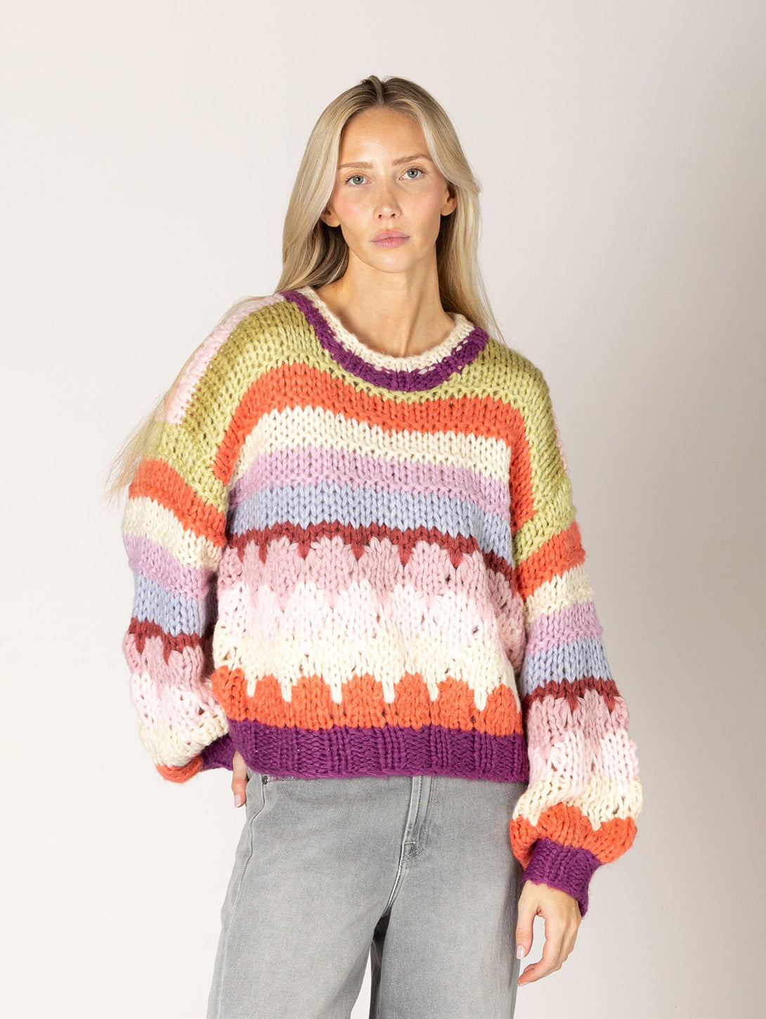 Chunky knit multicolor striped sweater with purple trim and open-knit detail