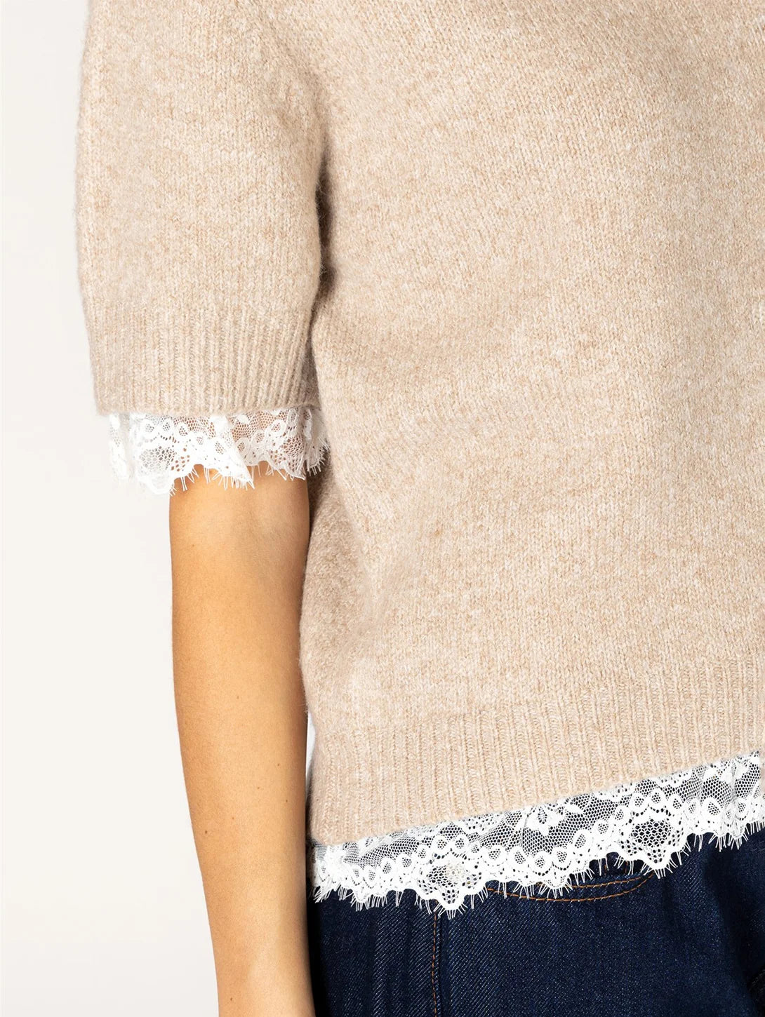 Beige short-sleeve knit sweater with white lace trim at hem and sleeves