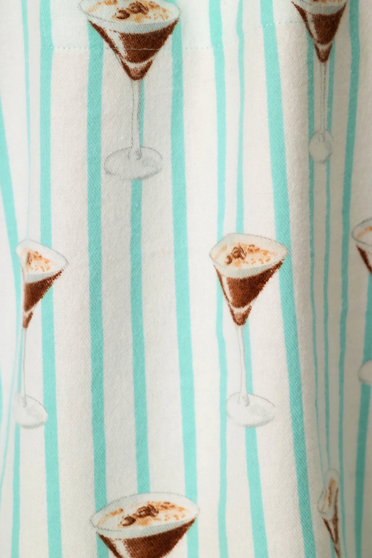 Pool blue striped pyjama fabric with espresso martini cocktail glass print pattern