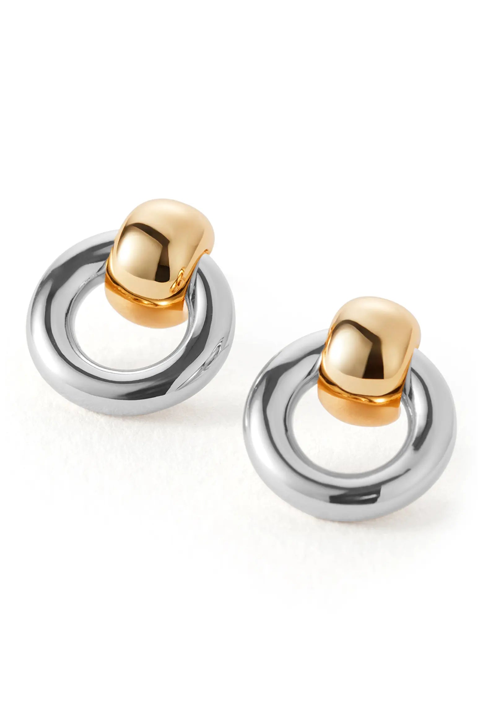 Gold and silver two-tone hoop earrings with rounded gold accents on a white background.