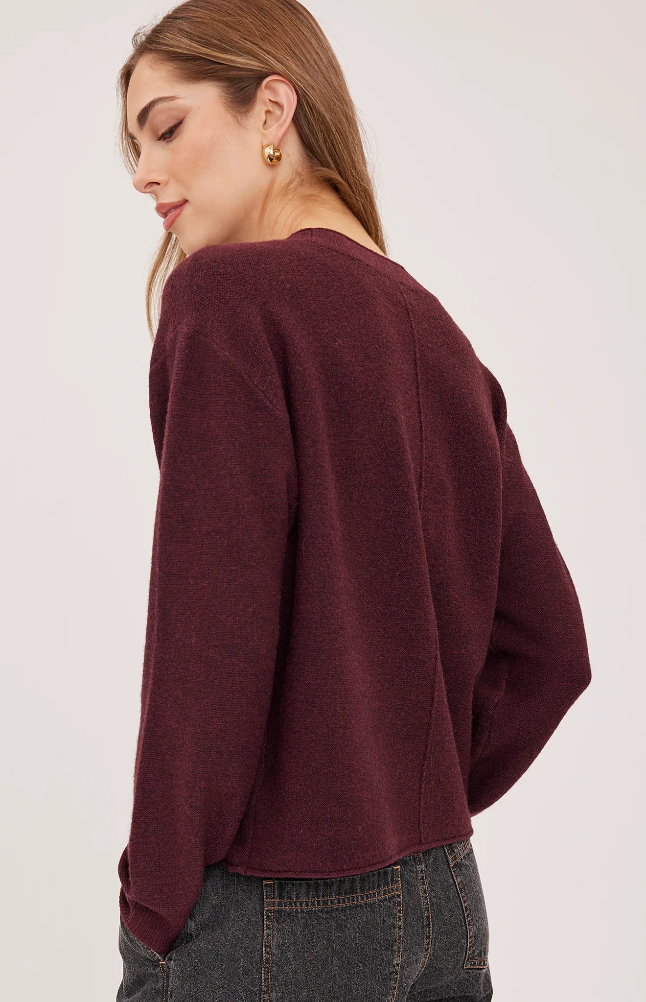 Gentle Fawn Wanda burgundy knit sweater, back view, worn with gray jeans