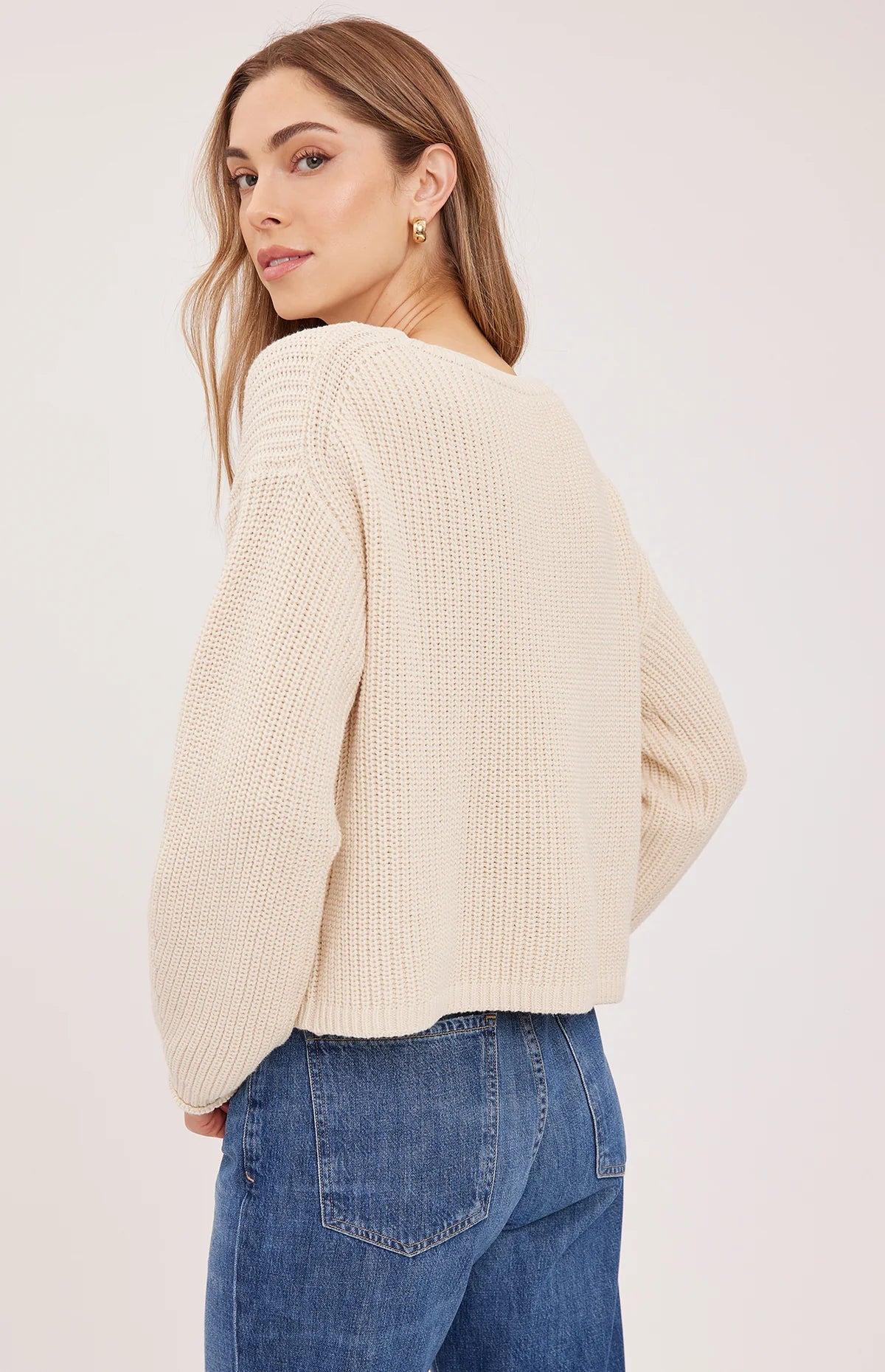 Gentle Fawn Isadora cream ribbed knit sweater, back view, paired with blue jeans
