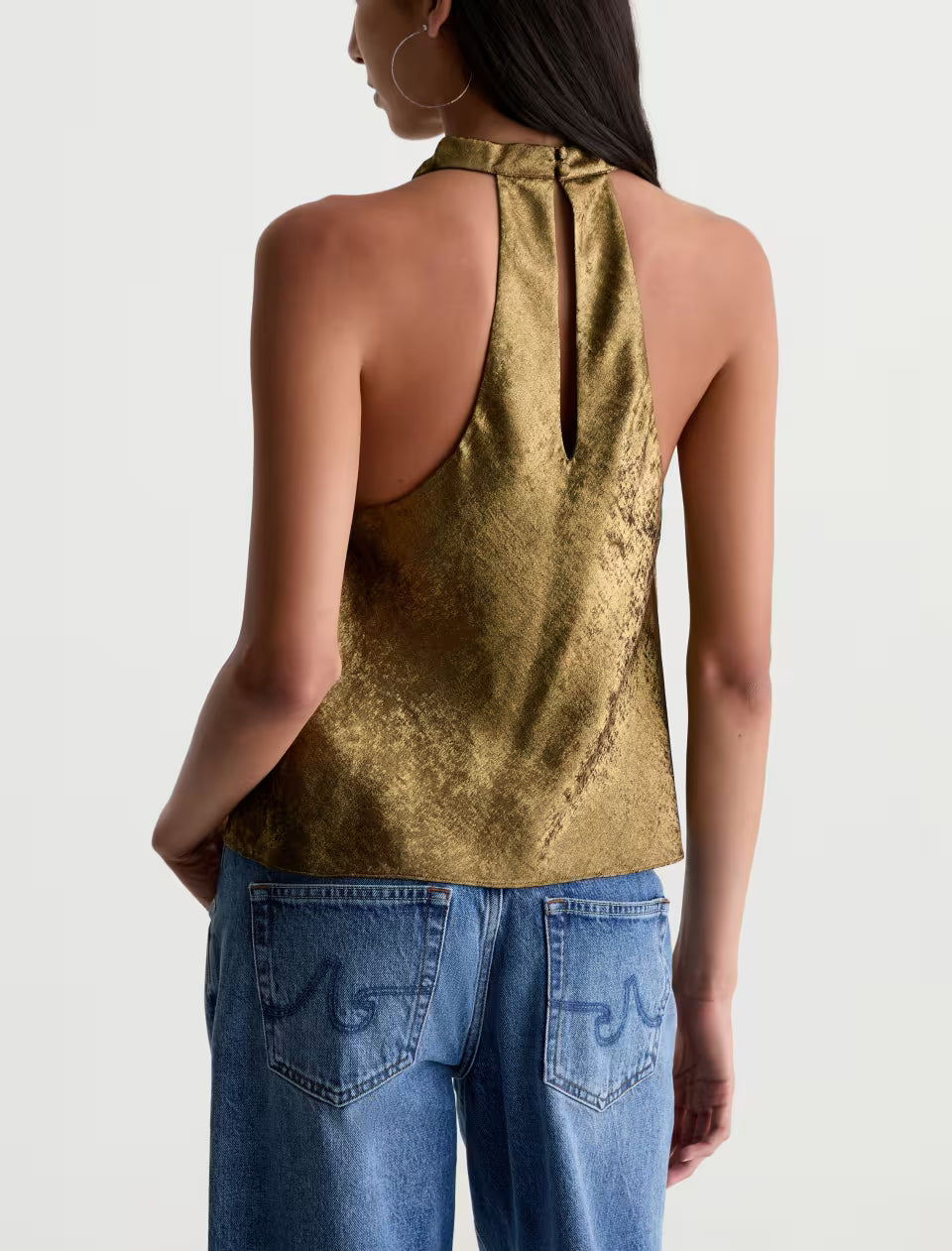 AG Kacey gold metallic halter top with racerback and keyhole detail, paired with jeans