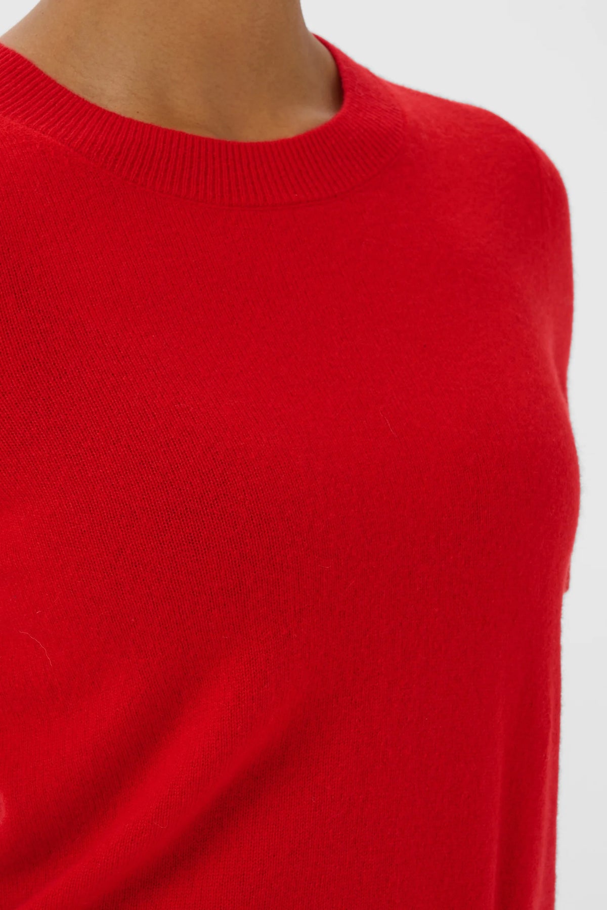 Red crew neck knit pullover sweater in vibrant goji berry color, close-up view