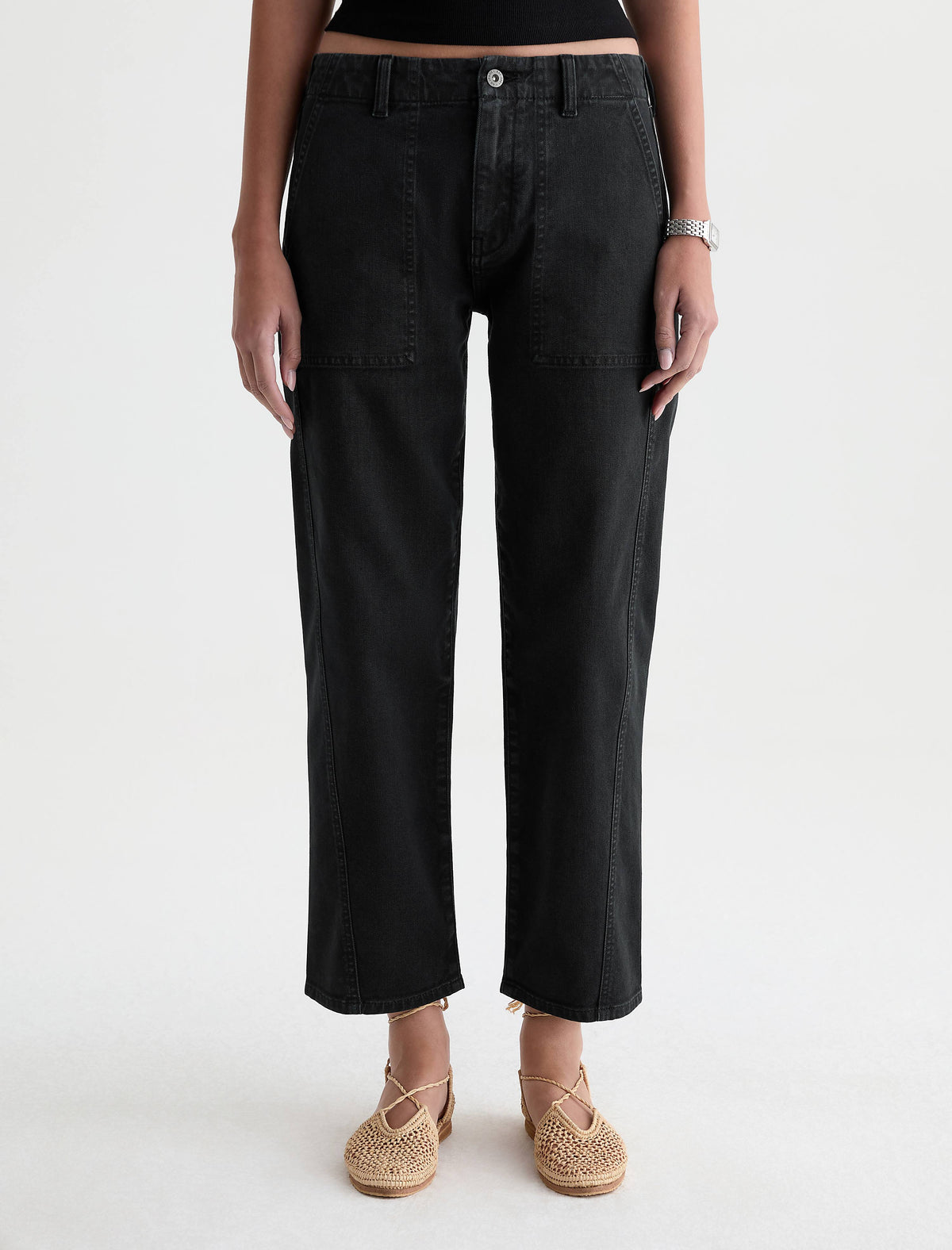 AG Analeigh pants in sulfur super black with patch pockets, worn by model with woven flats