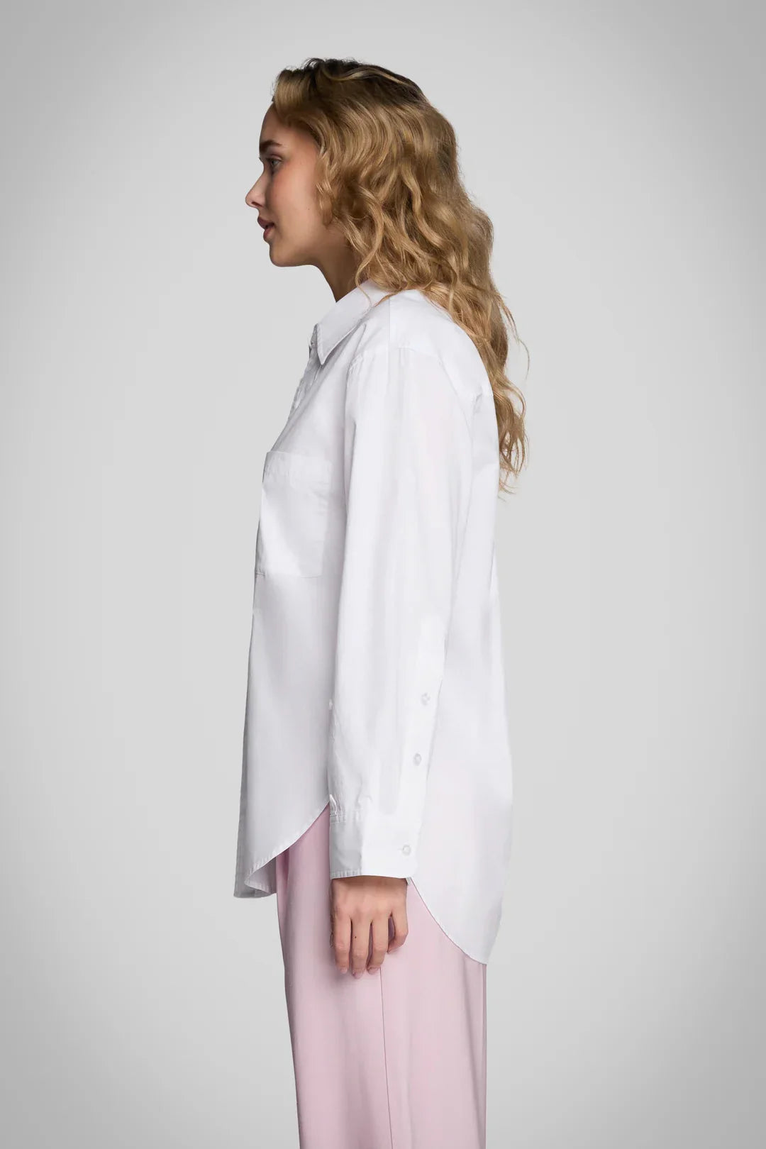 Pure & Simple white oversized long-sleeve button-up shirt with chest pocket, side view