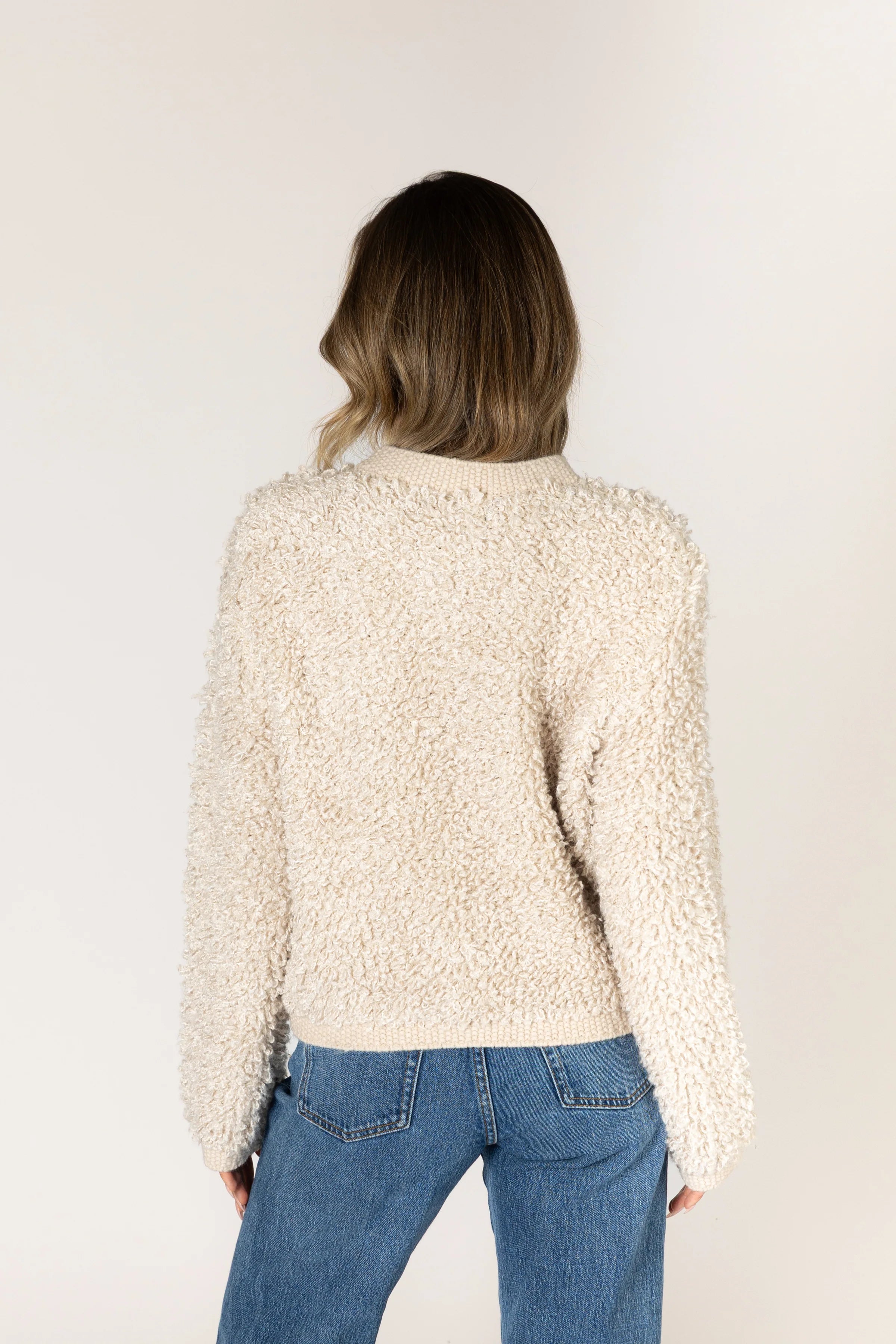 Lyla & Luxe Anika cream boucle knit sweater back view with blue jeans