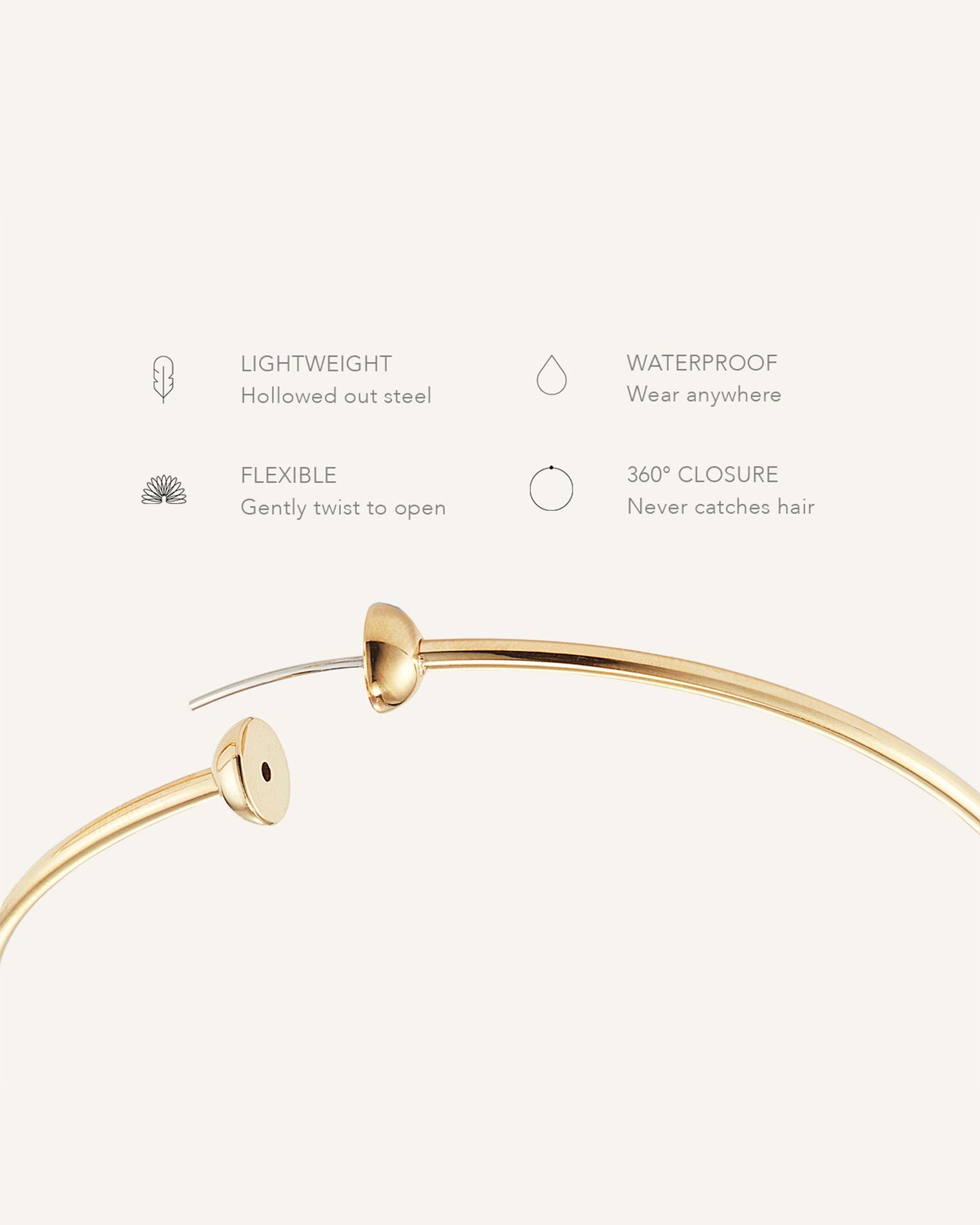 Gold hoop earring detail shot showing flexible closure mechanism with feature callouts