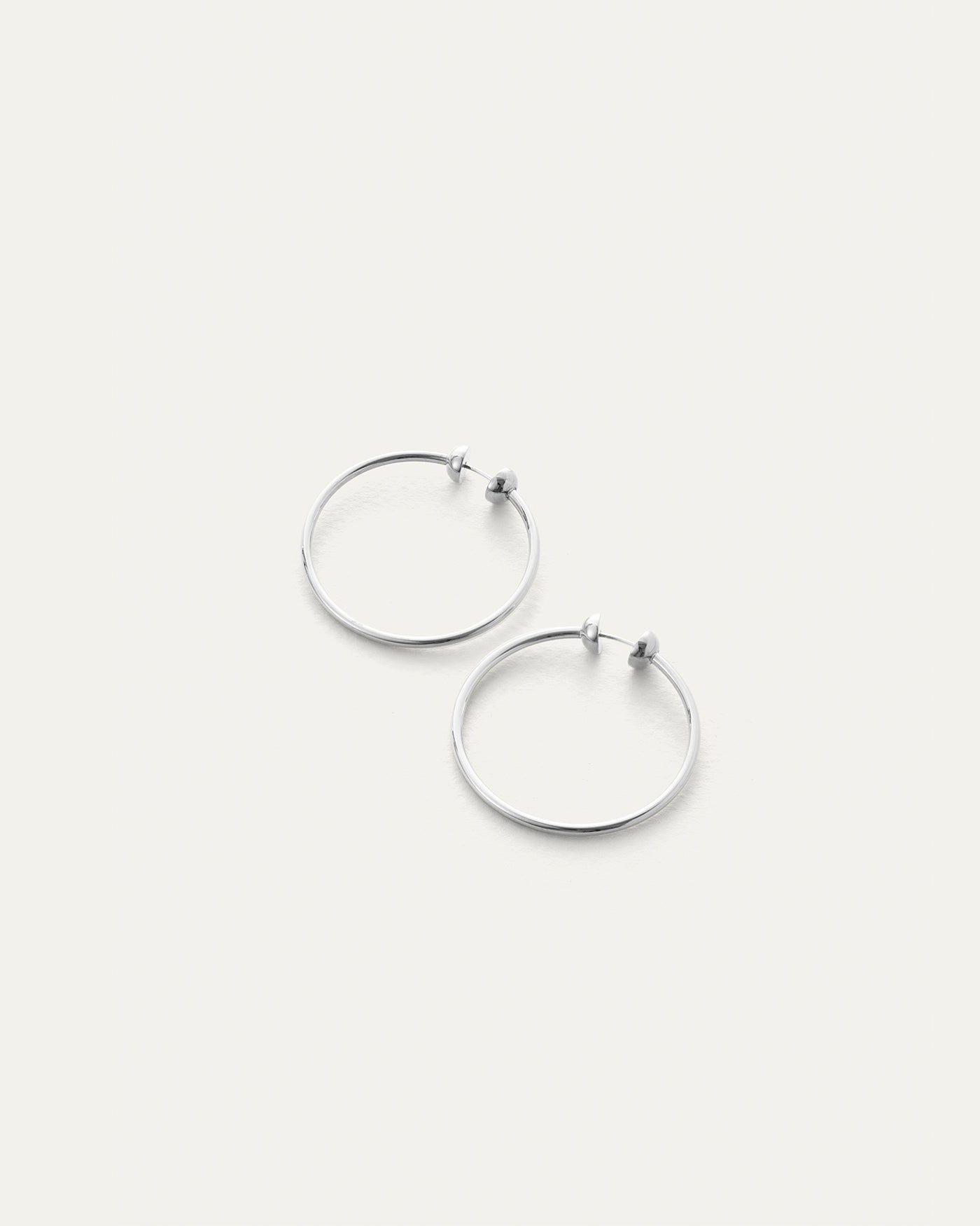 Jenny Bird Mini Icon Hoops in silver, thin circular hoop earrings with ball closure, pair shown