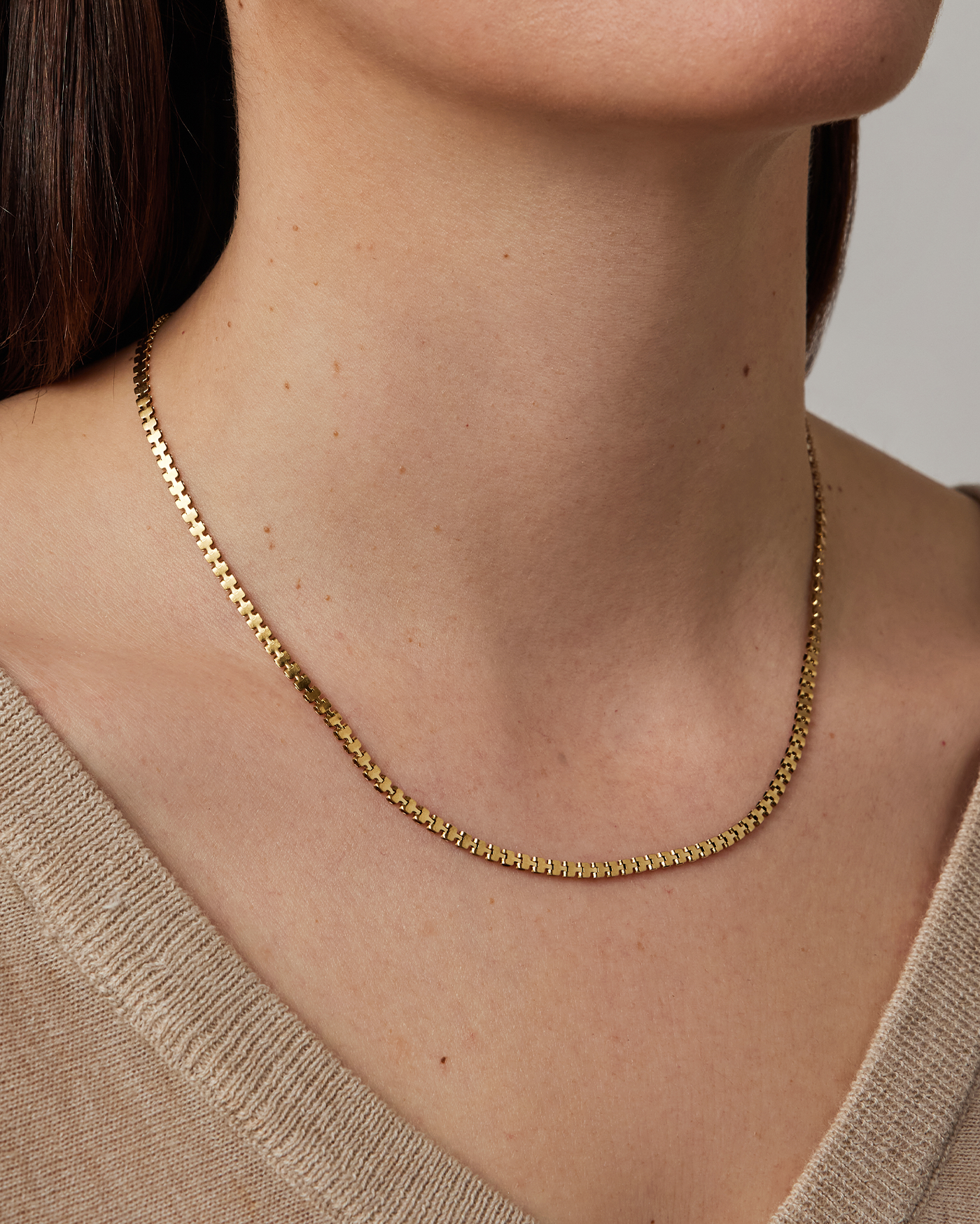 Model wearing Jenny Bird Double Amalfi gold box chain necklace on bare neck