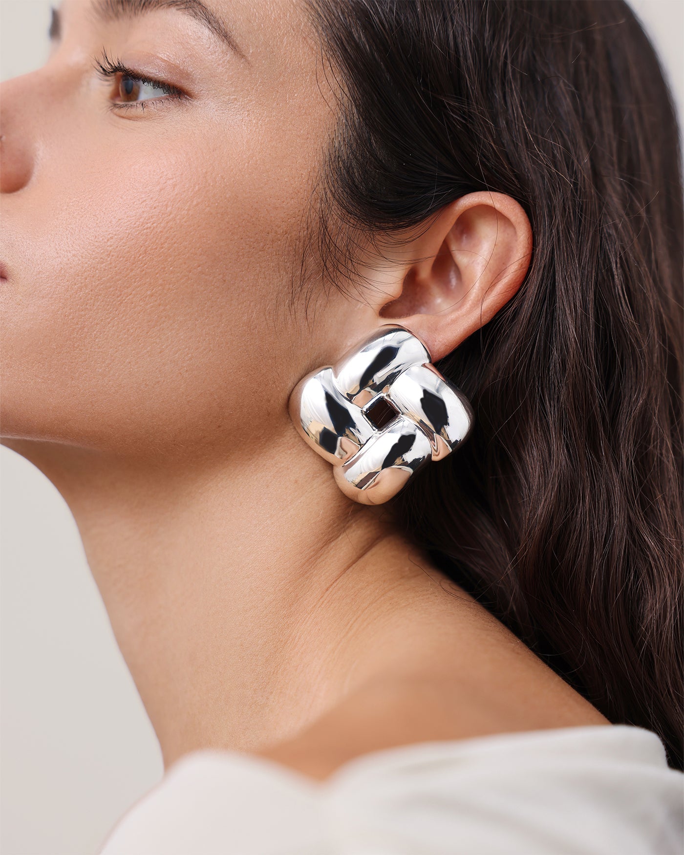 Model wearing large silver chunky knot-style statement stud earring by Jenny Bird