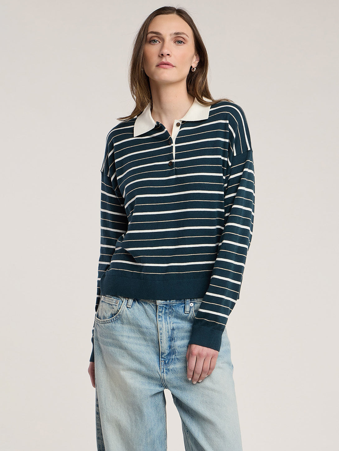 Model wearing Velvet Kaelin07 striped polo sweater in teal and cream with jeans