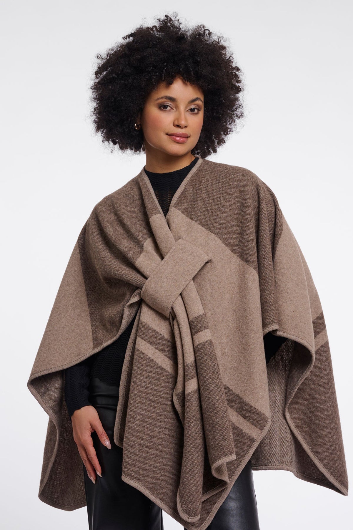Model wearing Rino & Pelle Levi oversized wrap cape in toffee check pattern