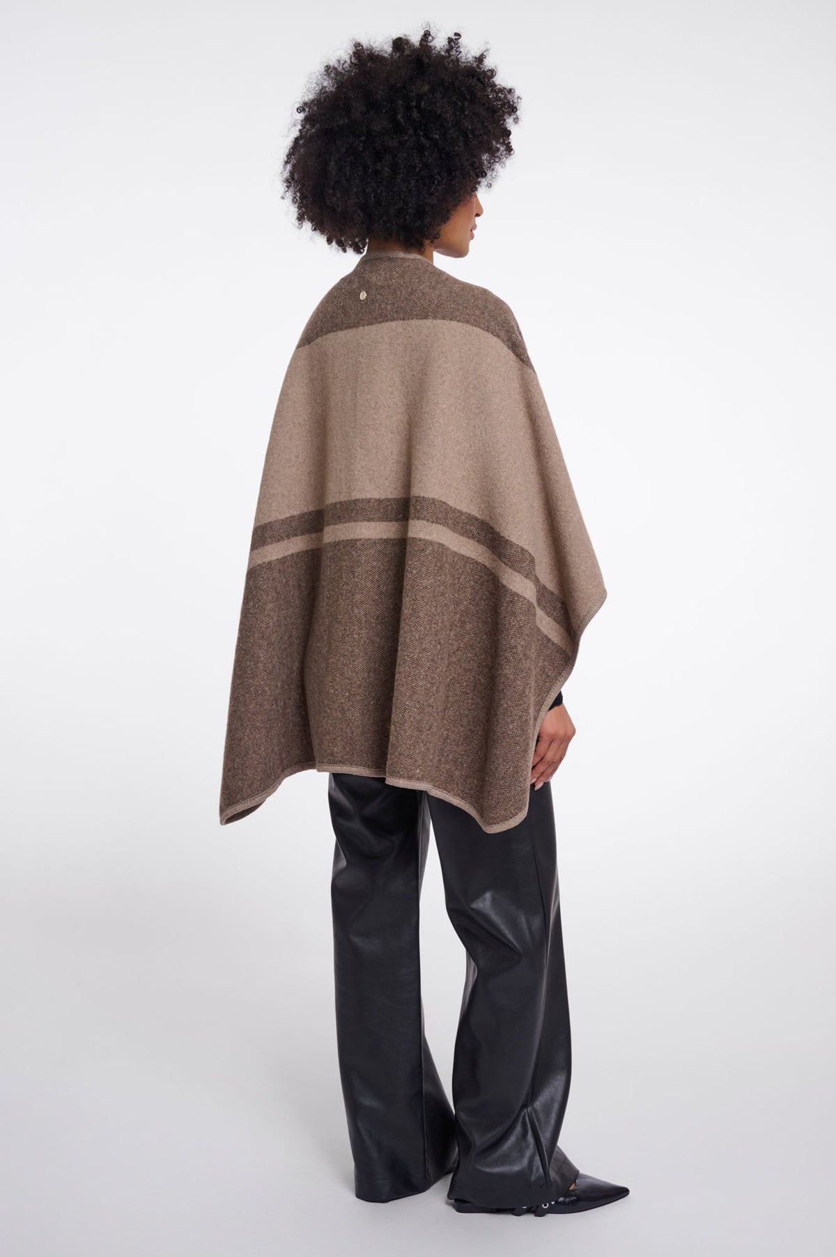 Back view of model wearing Rino & Pelle Levi wool cape poncho in toffee check colorway