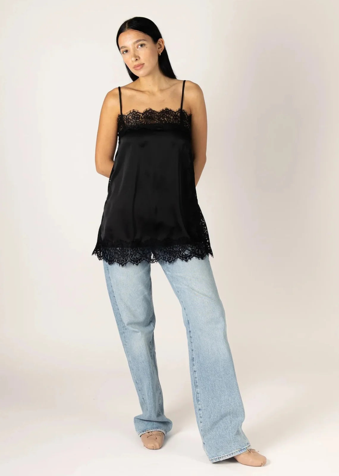 Black satin lace-trim cami top with spaghetti straps, worn with light wash jeans