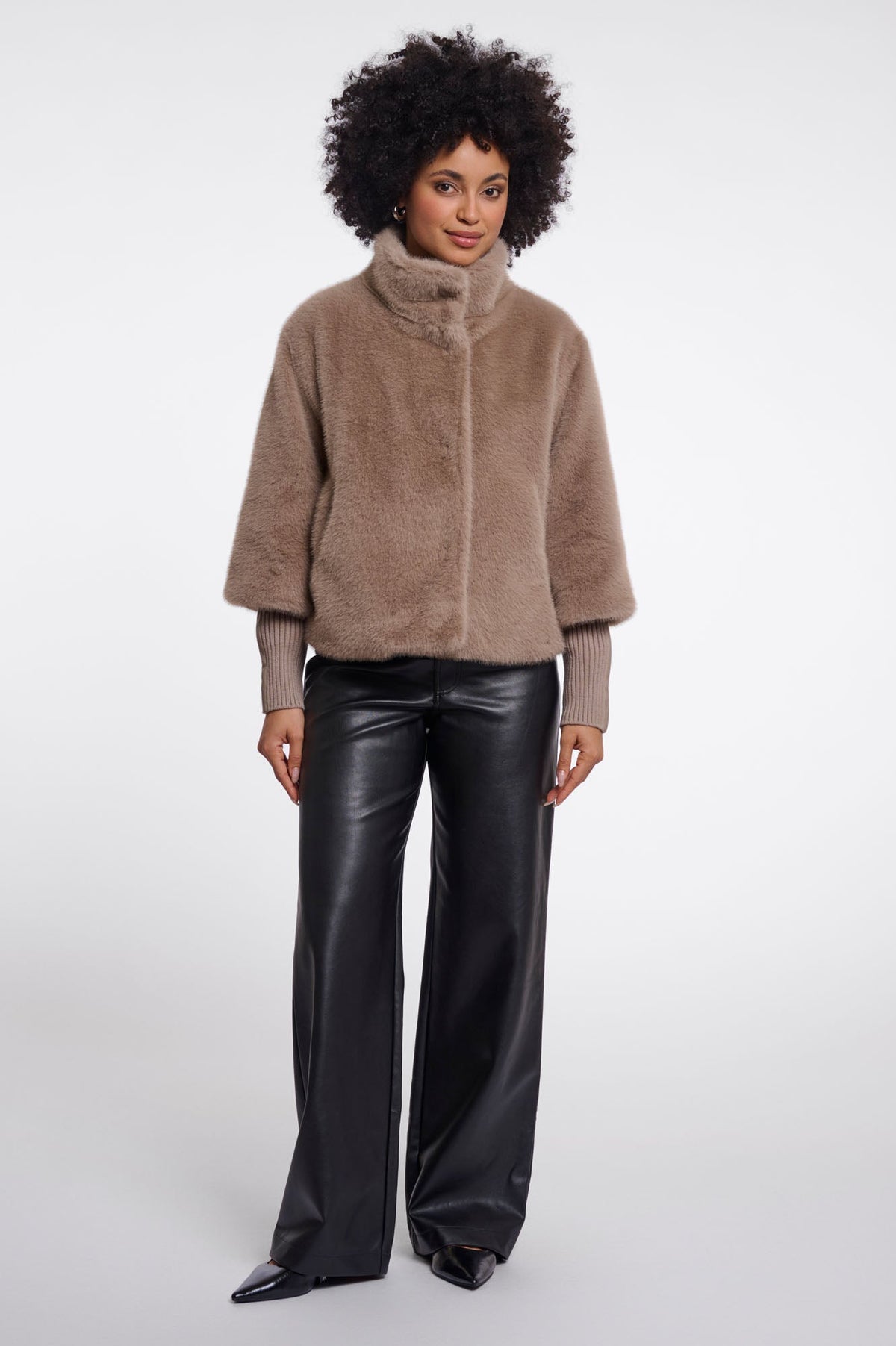 Model wearing RINO & PELLE NESRIN faux fur jacket in mocha latte with black leather trousers