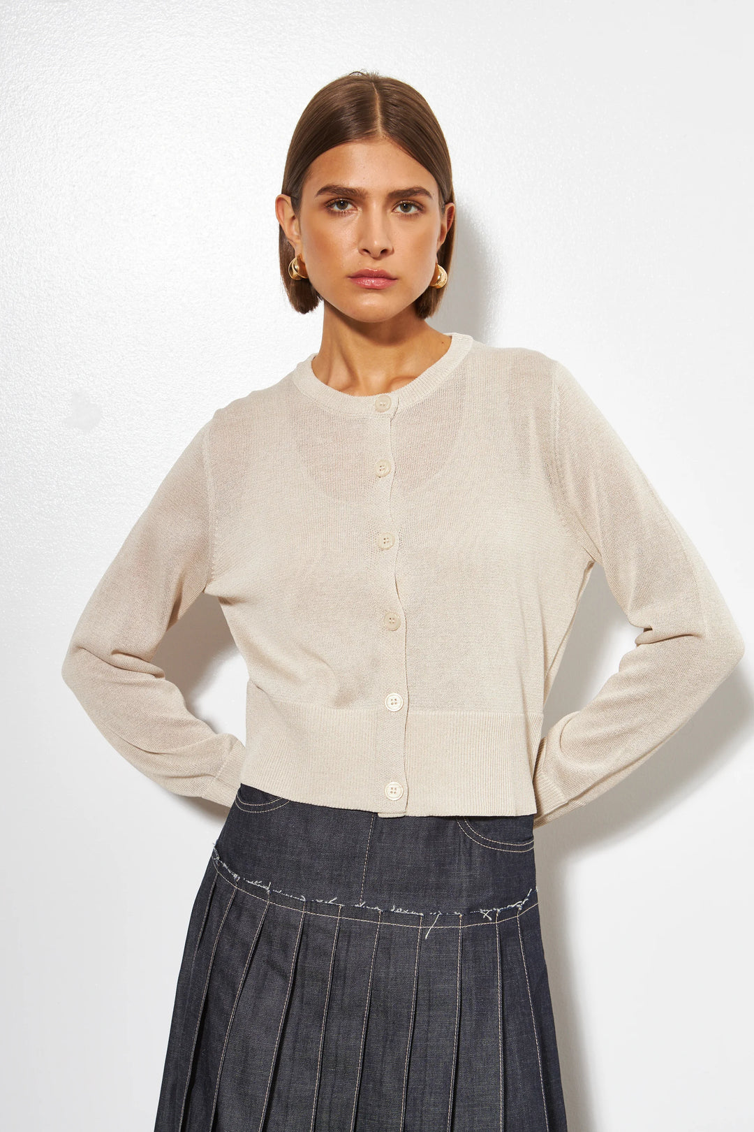 Cream lightweight sheer knit cardigan with round neck and button front closure