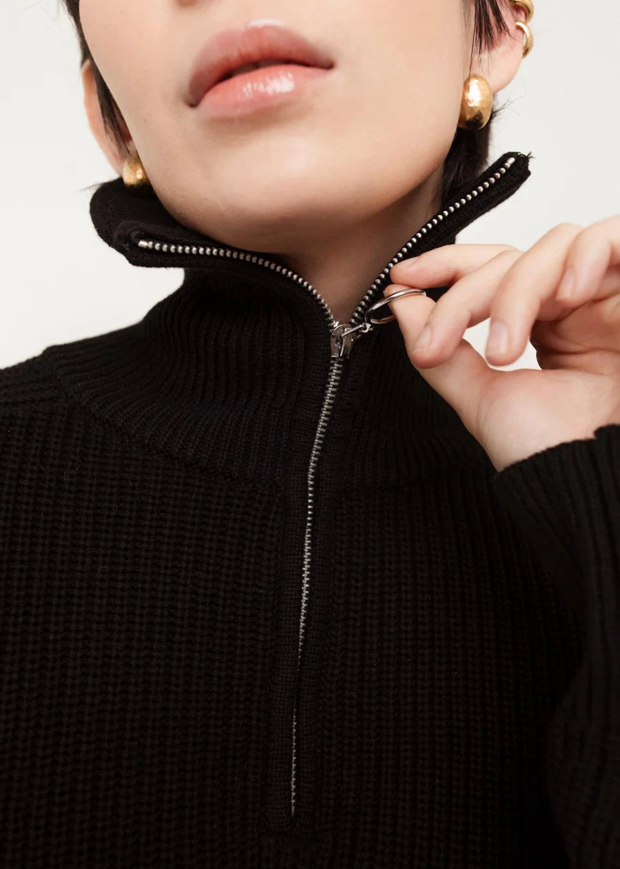 Black ribbed knit funnel neck zip sweater with silver zipper pull detail