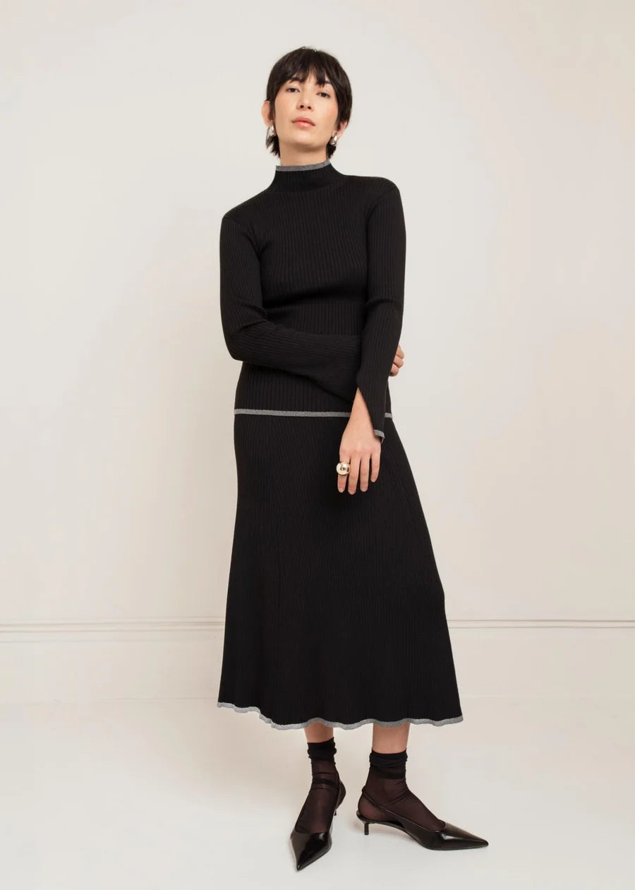 Black ribbed knit midi skirt with contrast grey trim detail at waist and hem