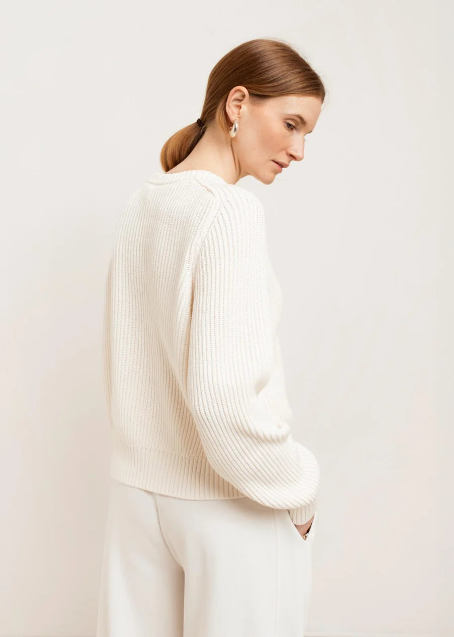 White ribbed knit crew neck sweater with long sleeves, back view