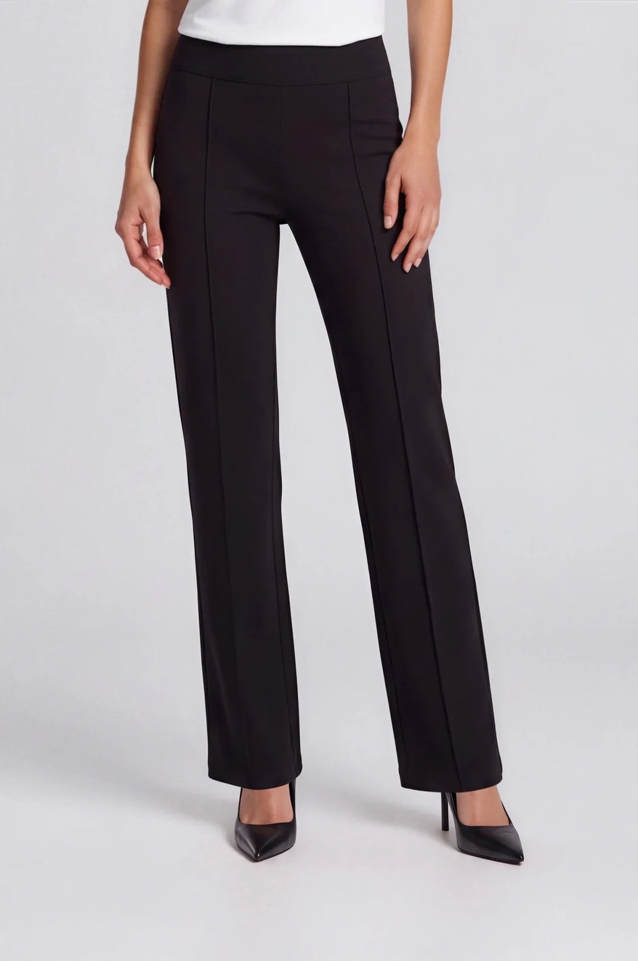 Black wide-leg ponte pants with front seam detail, worn with black heels.