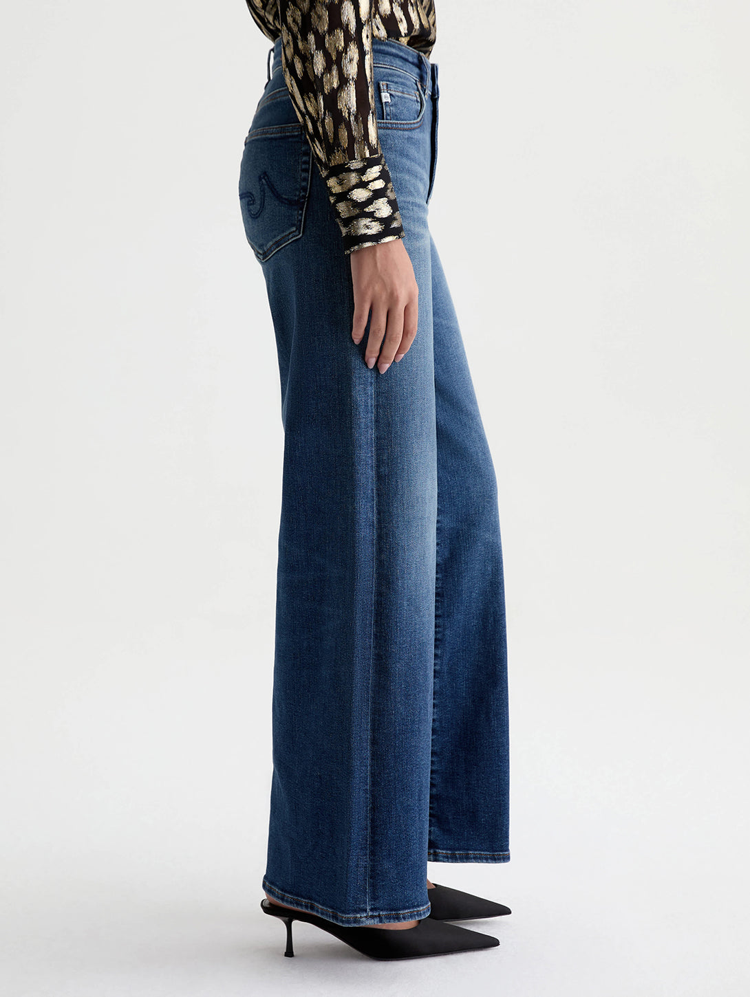 Side view of AG Saige Wide Leg jeans in 14 Years Bluegrass medium blue wash on model