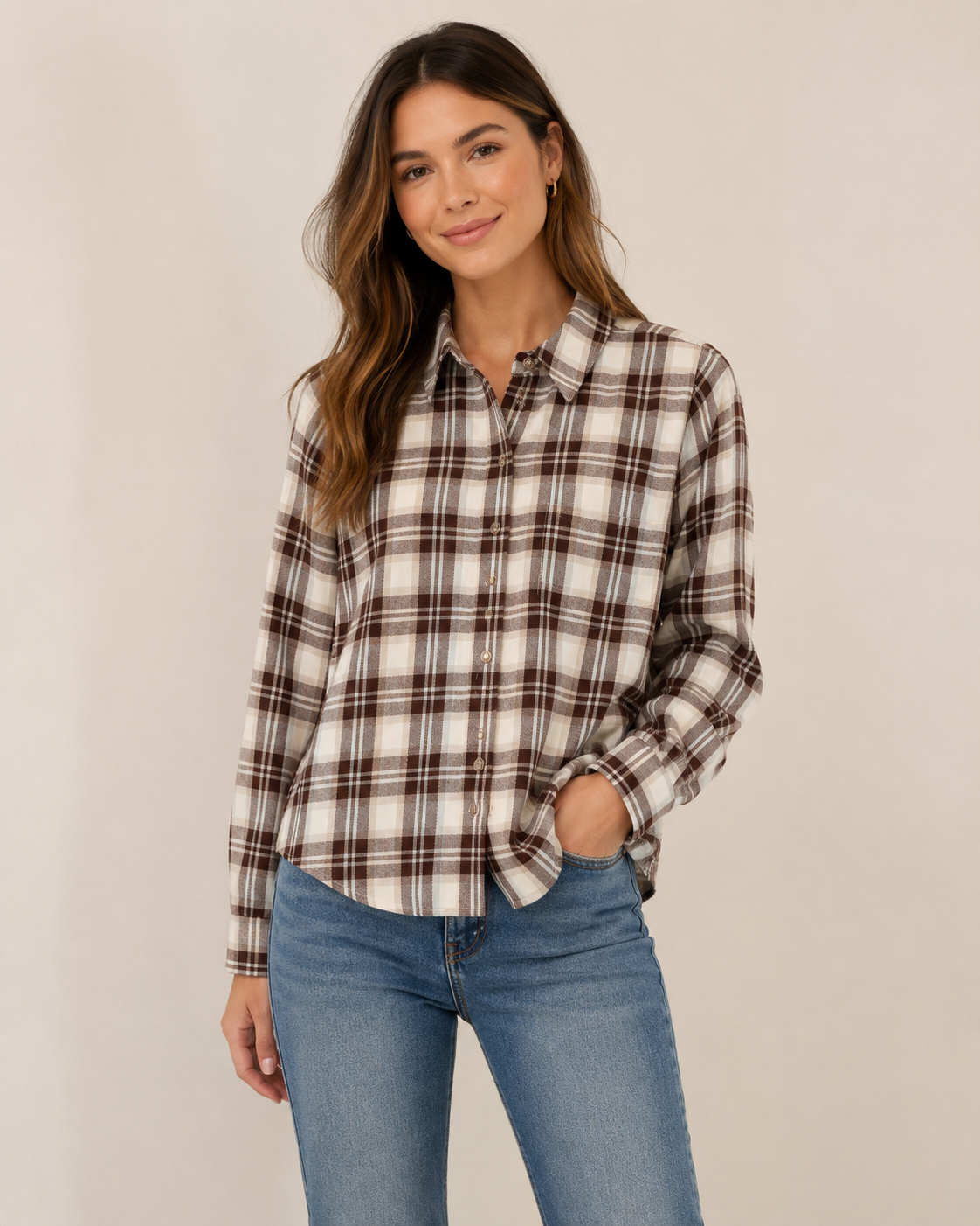 Woman wearing Rails Malin plaid flannel shirt in cream and brown birch hickory colorway with jeans