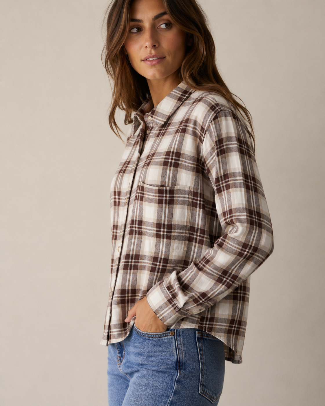 Woman wearing Rails Malin plaid flannel shirt in cream and brown birch hickory colorway with jeans