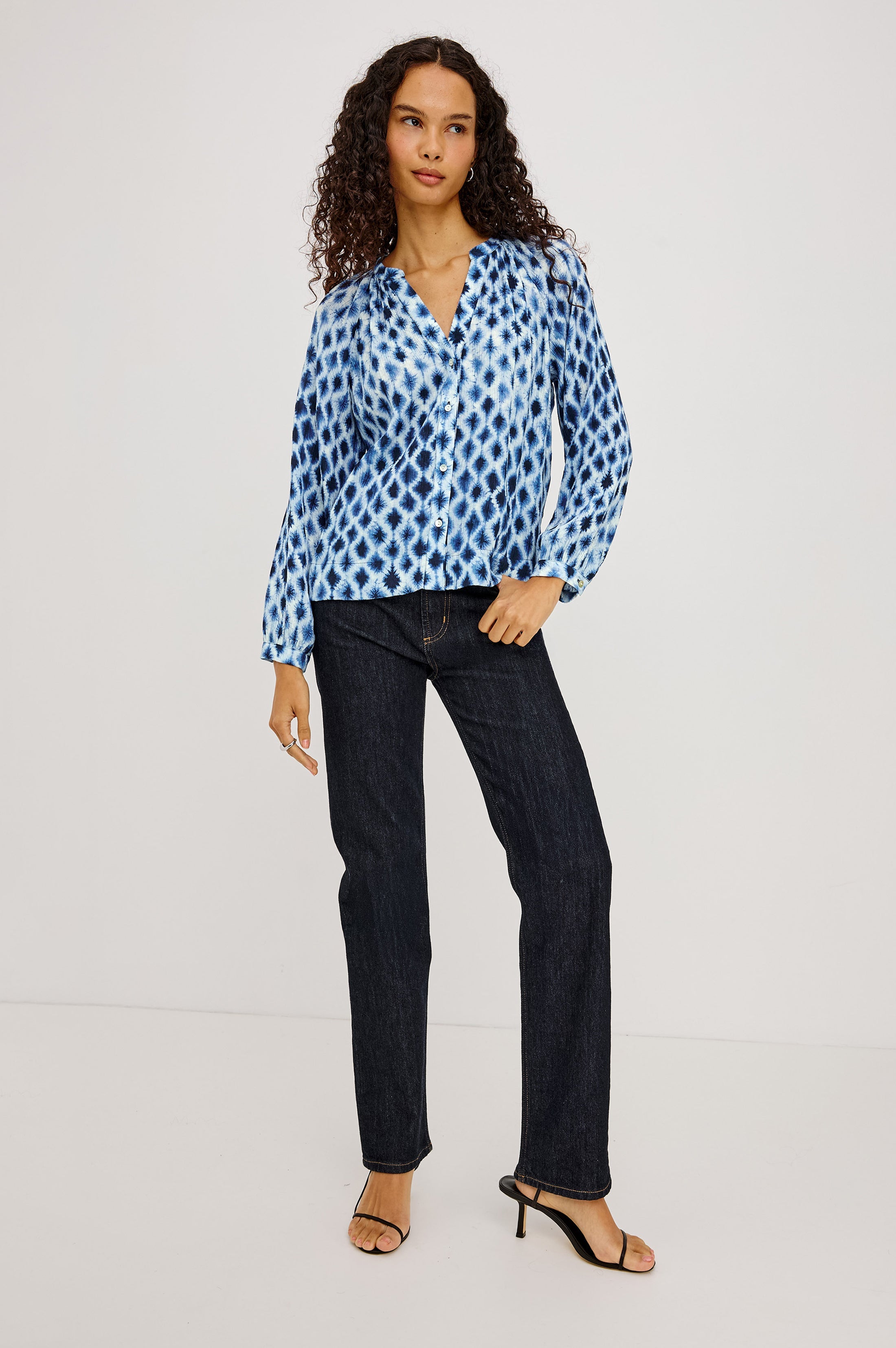 Model wearing Rails Saint blouse in Sapphire Shibori print with dark jeans and heels