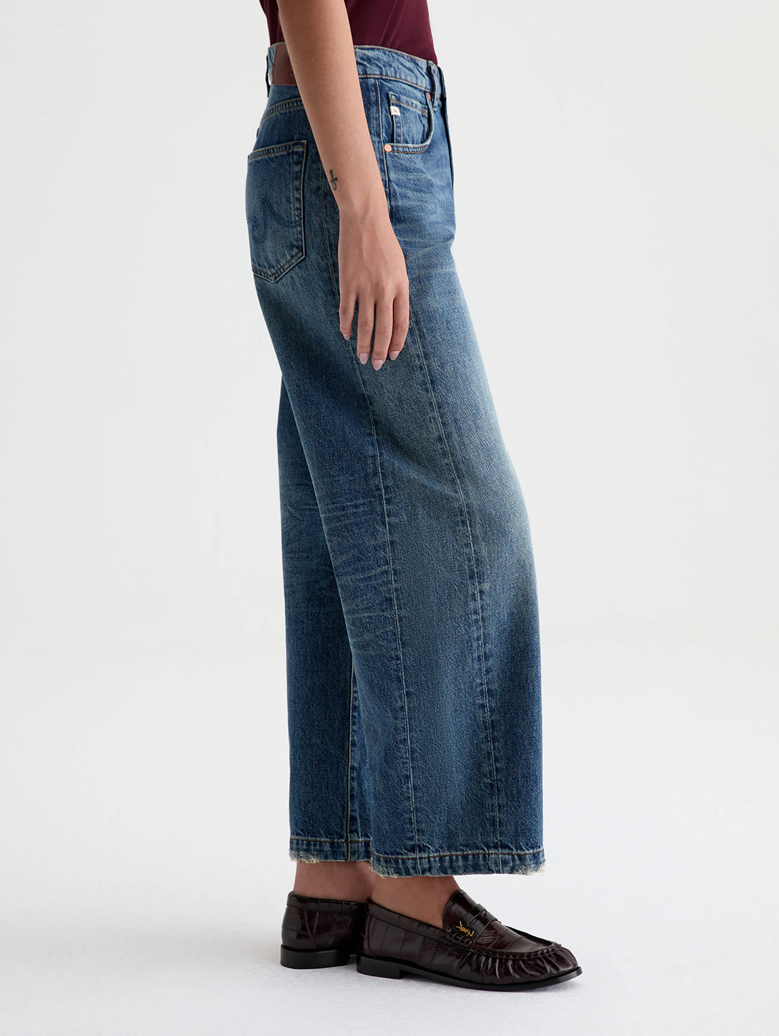 Side view of AG Hattie wide-leg denim jeans in 10 Yrs Front Line medium blue wash