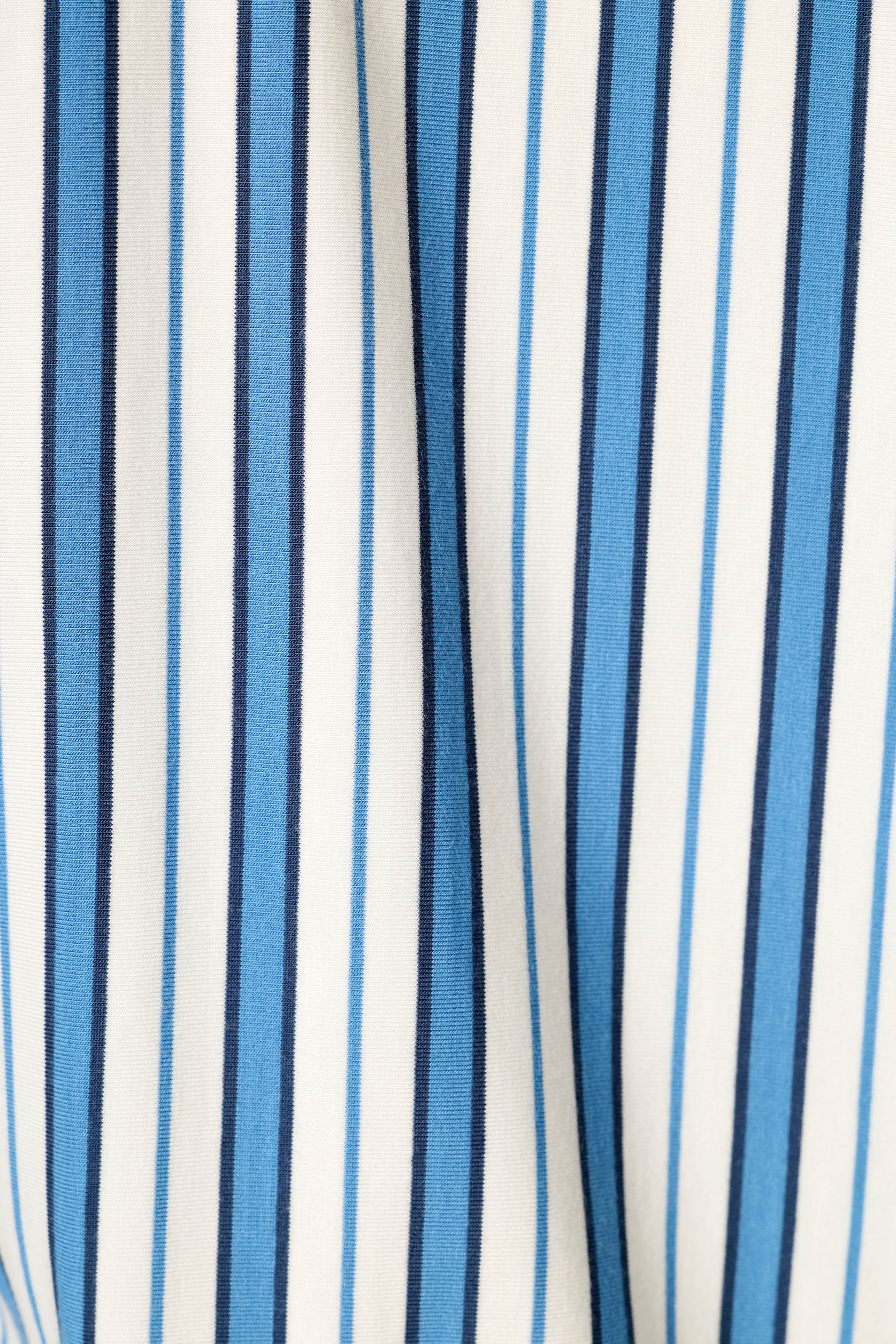 Close-up detail of blue, navy, and white vertical stripe fabric pattern for PJ Salvage night shirt