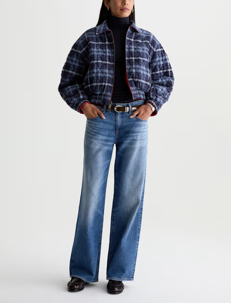 Light blue wide-leg jeans with medium wash fading and brown belt on model