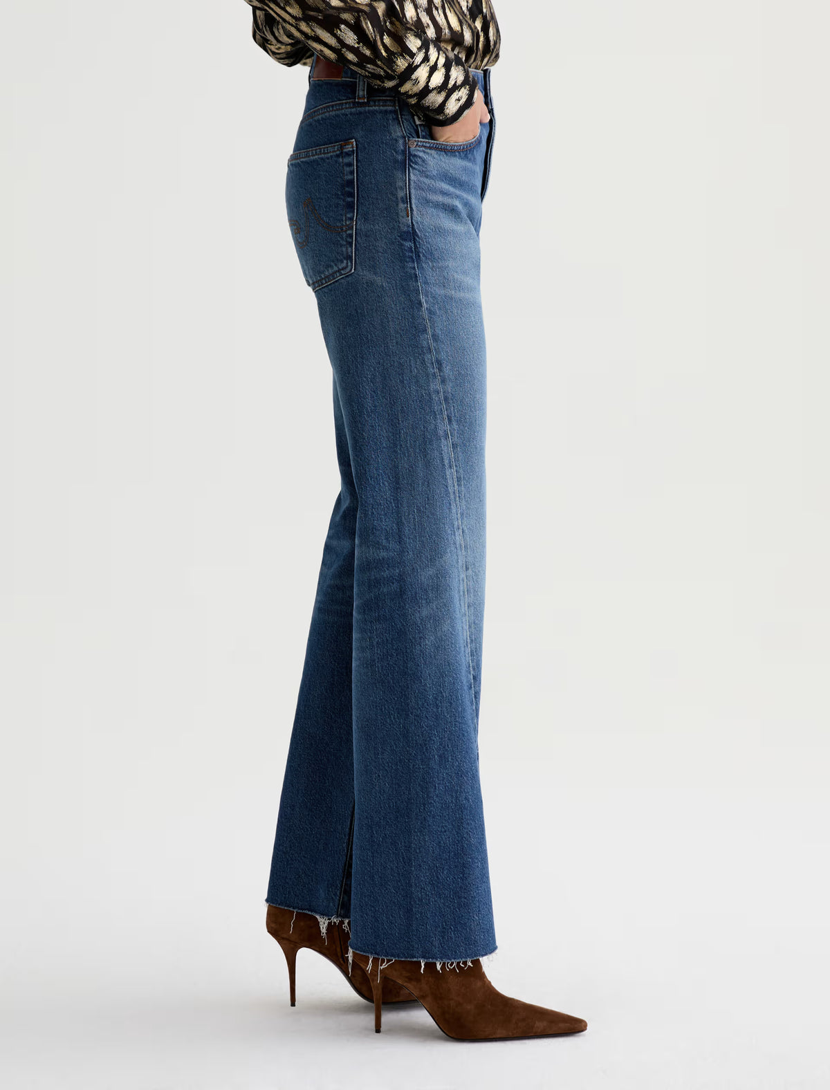 AG Sydney wide-leg flare jeans in medium blue wash with raw hem, side view