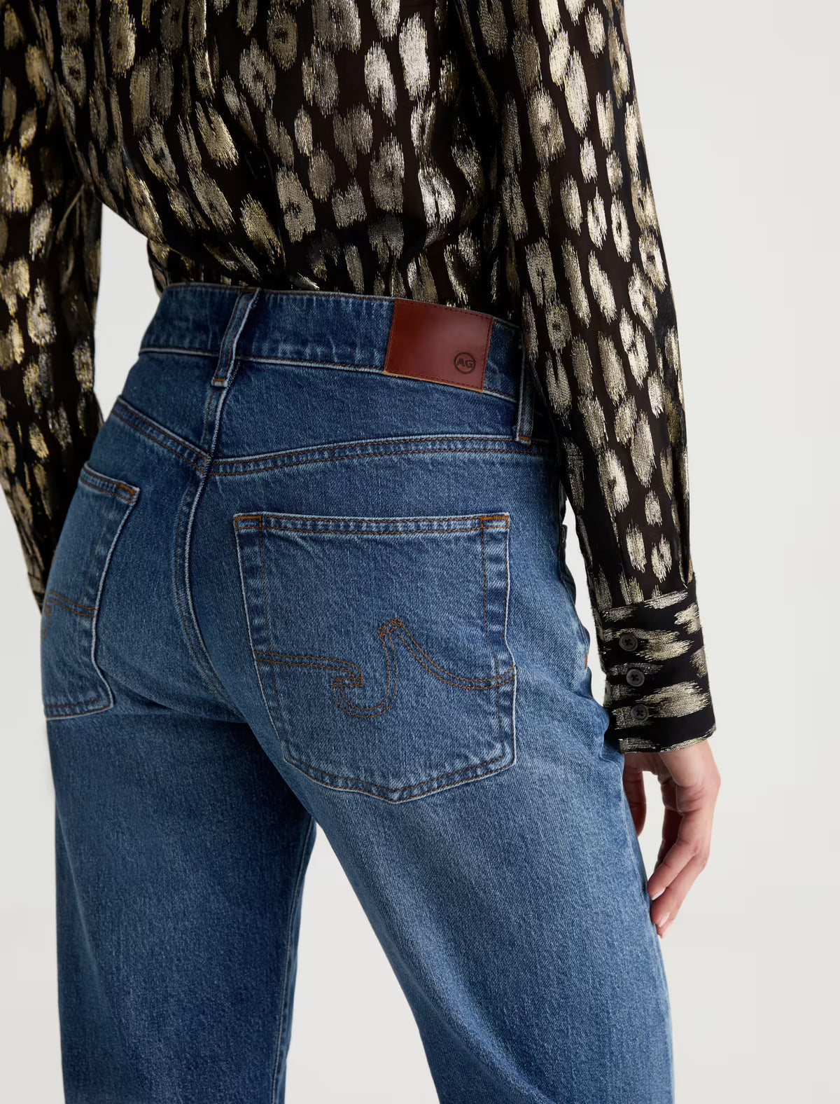 AG Sydney straight jeans in mid-blue wash, back view with signature pocket stitching