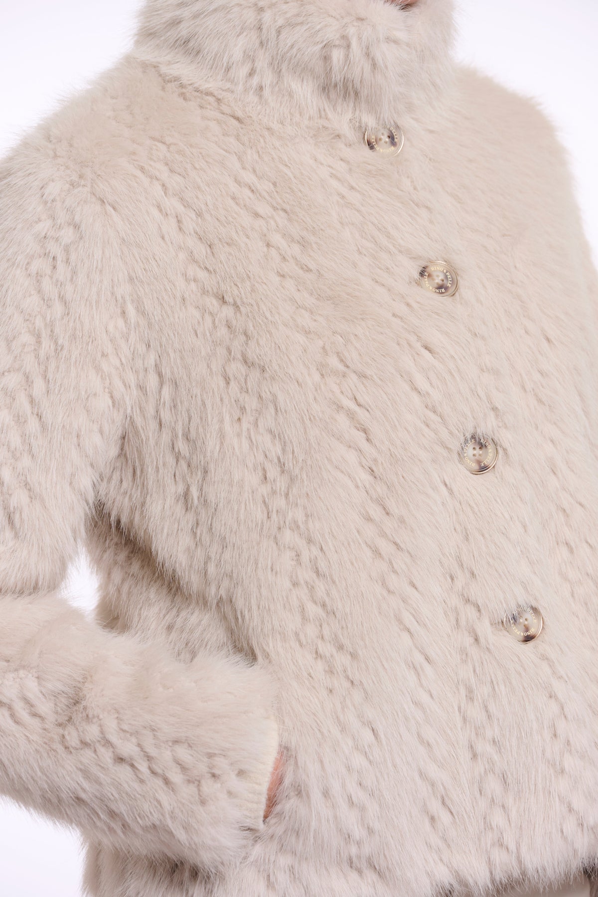 Close-up detail of Rino & Pelle VIE fur jacket in birch showing gold buttons and texture