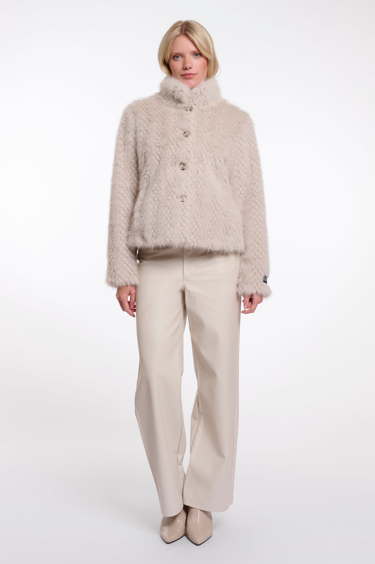 Model wearing Rino & Pelle VIE fluffy textured jacket in birch with cream wide-leg trousers