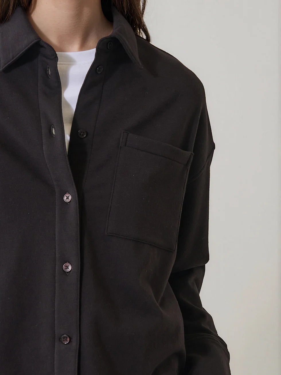 Dark brown boxy button-up shirt with chest pocket and spread collar